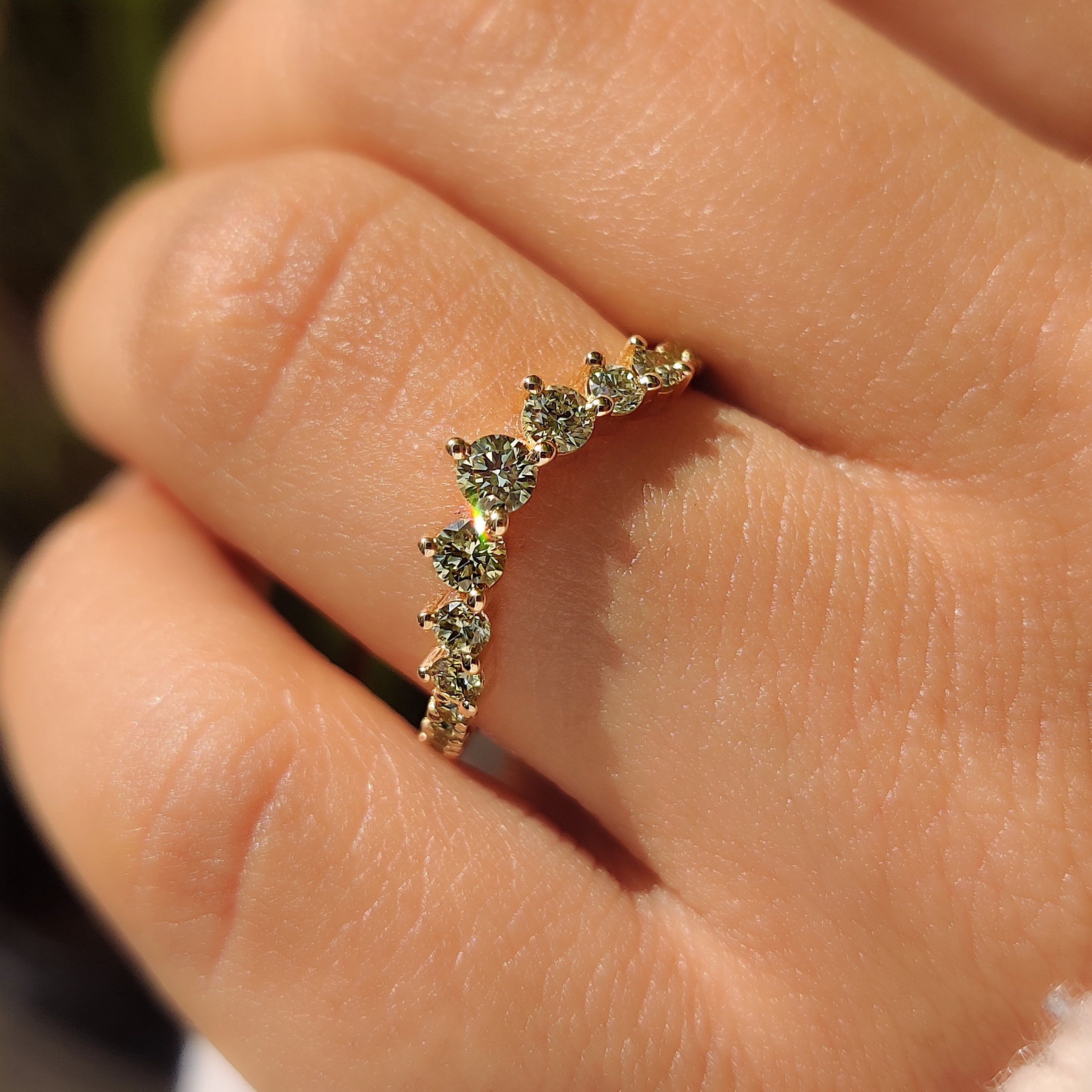 Green round diamond wedding band with V shaped design
