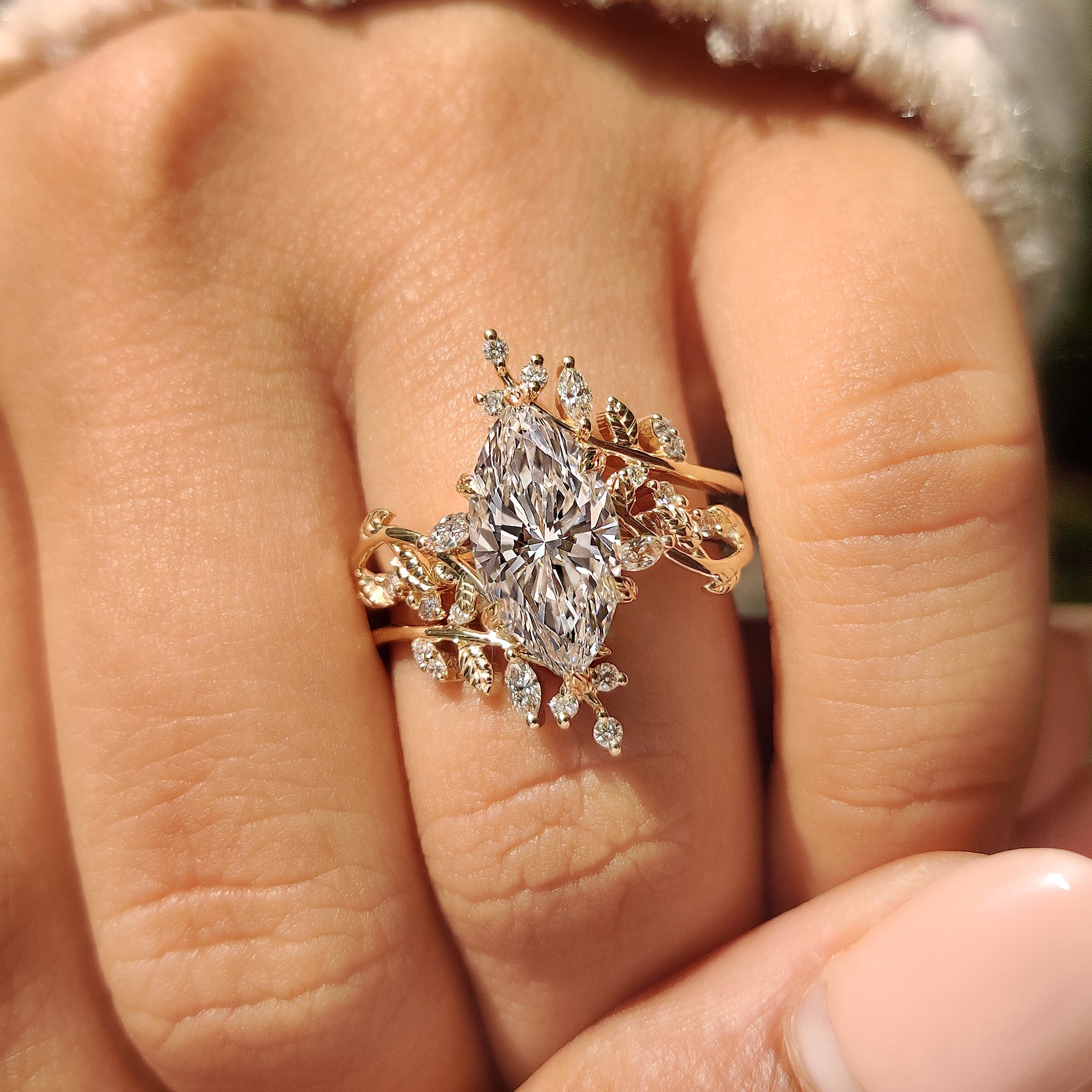Handmade marquise engagement ring with round diamond side stones

