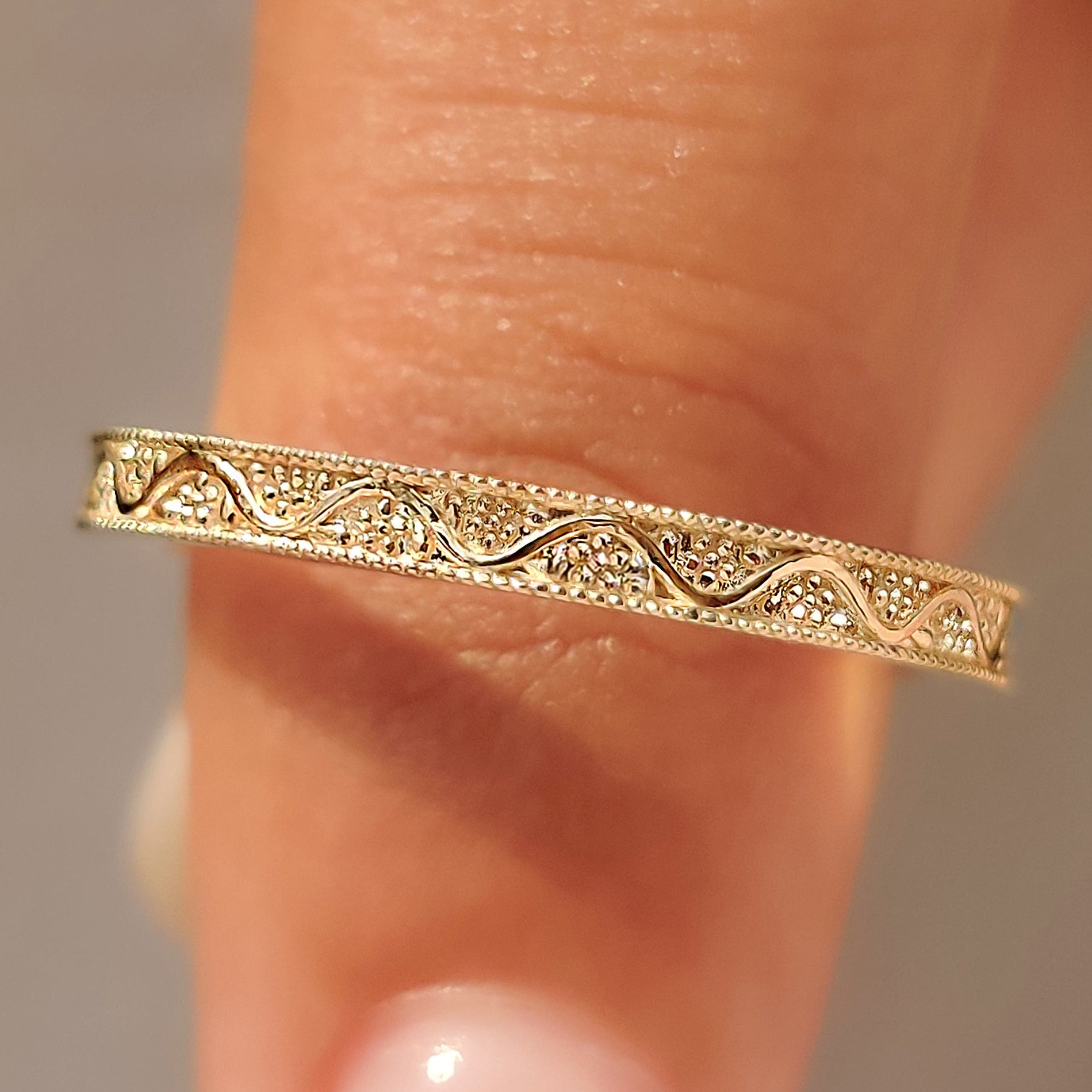 Milgrain wedding band with hand engraved flower and vine pattern.
