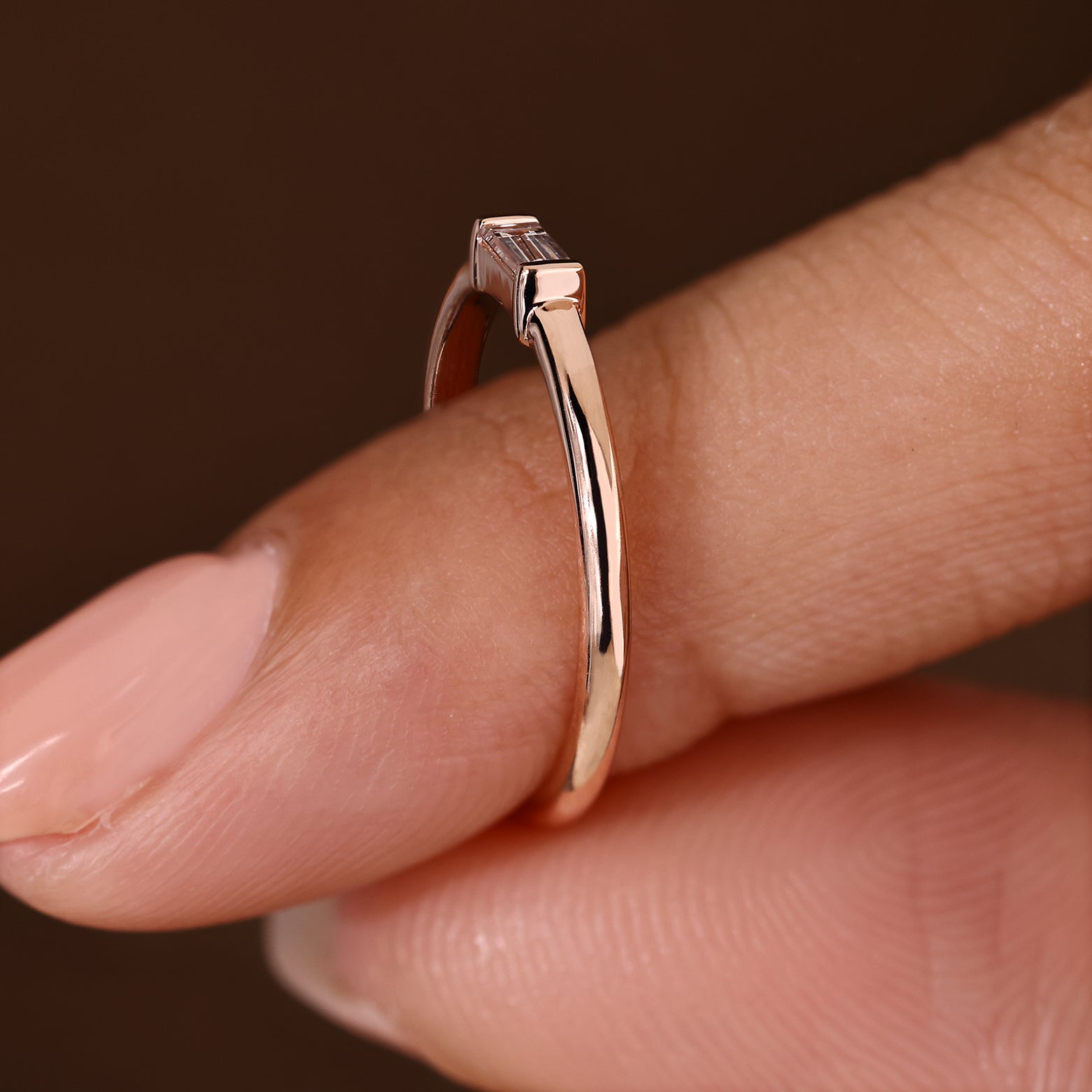 Baguette diamond band with solitaire style and bezel setting
