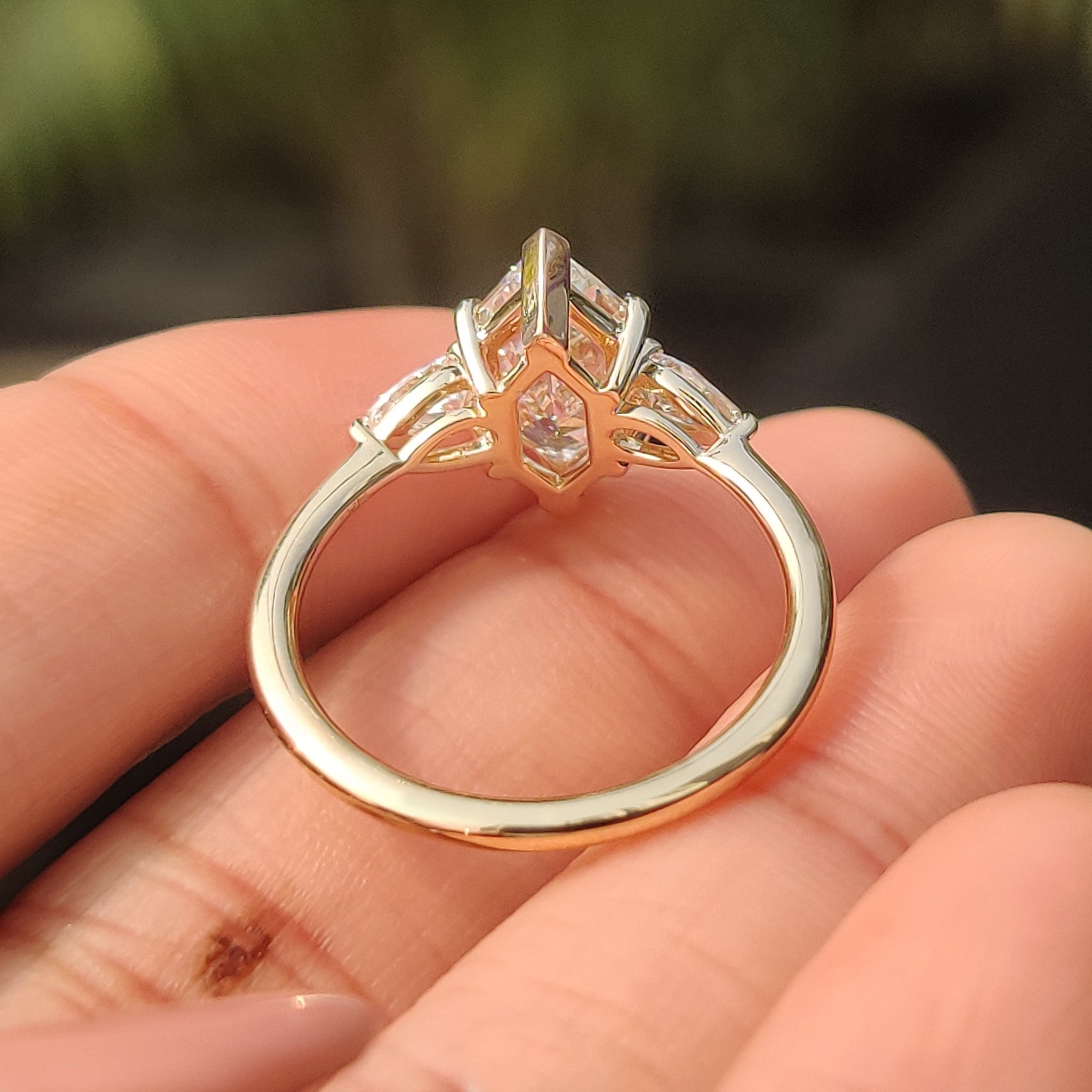 Three stone engagement ring with tapered shank design
