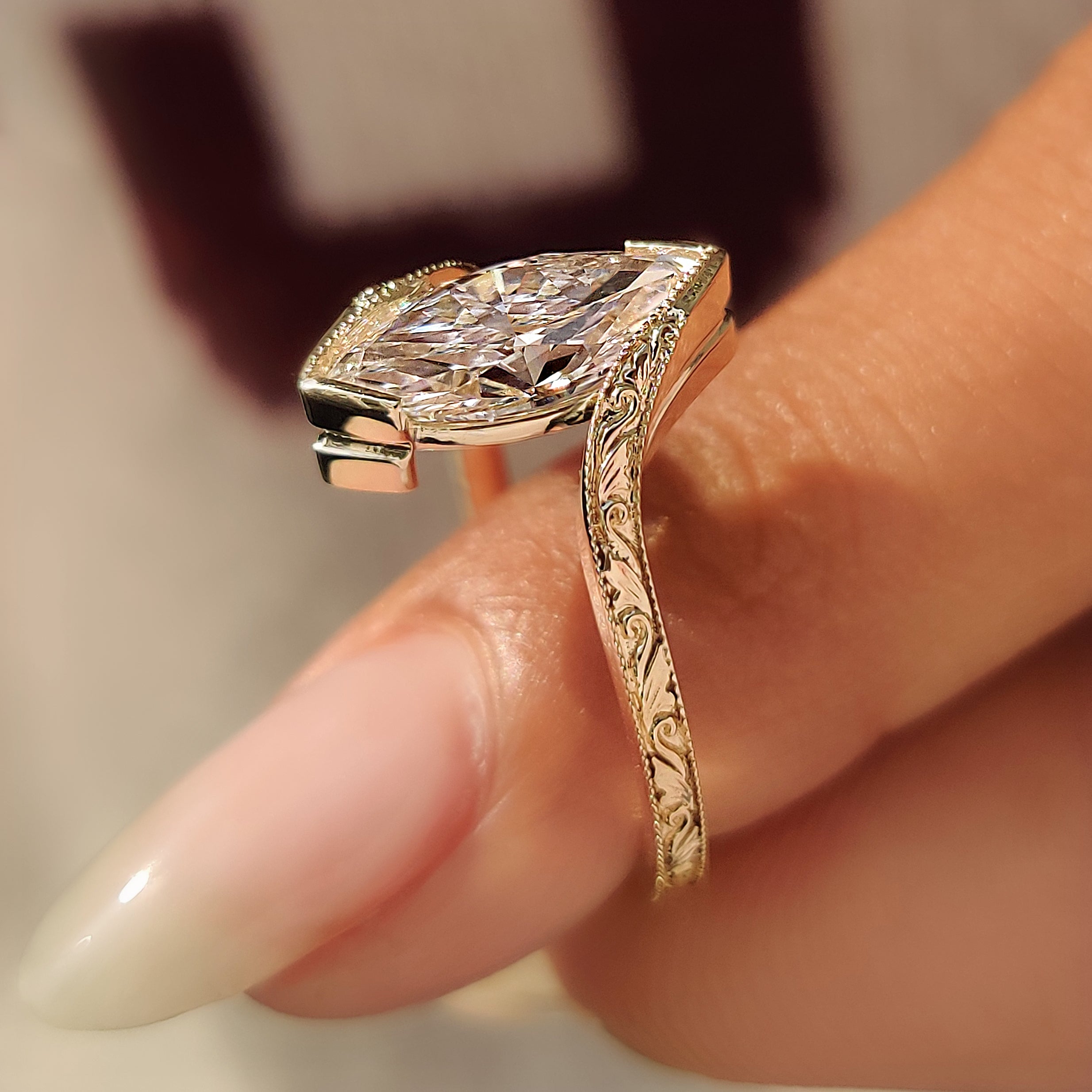 Marquise solitaire ring with curved bypass band.
