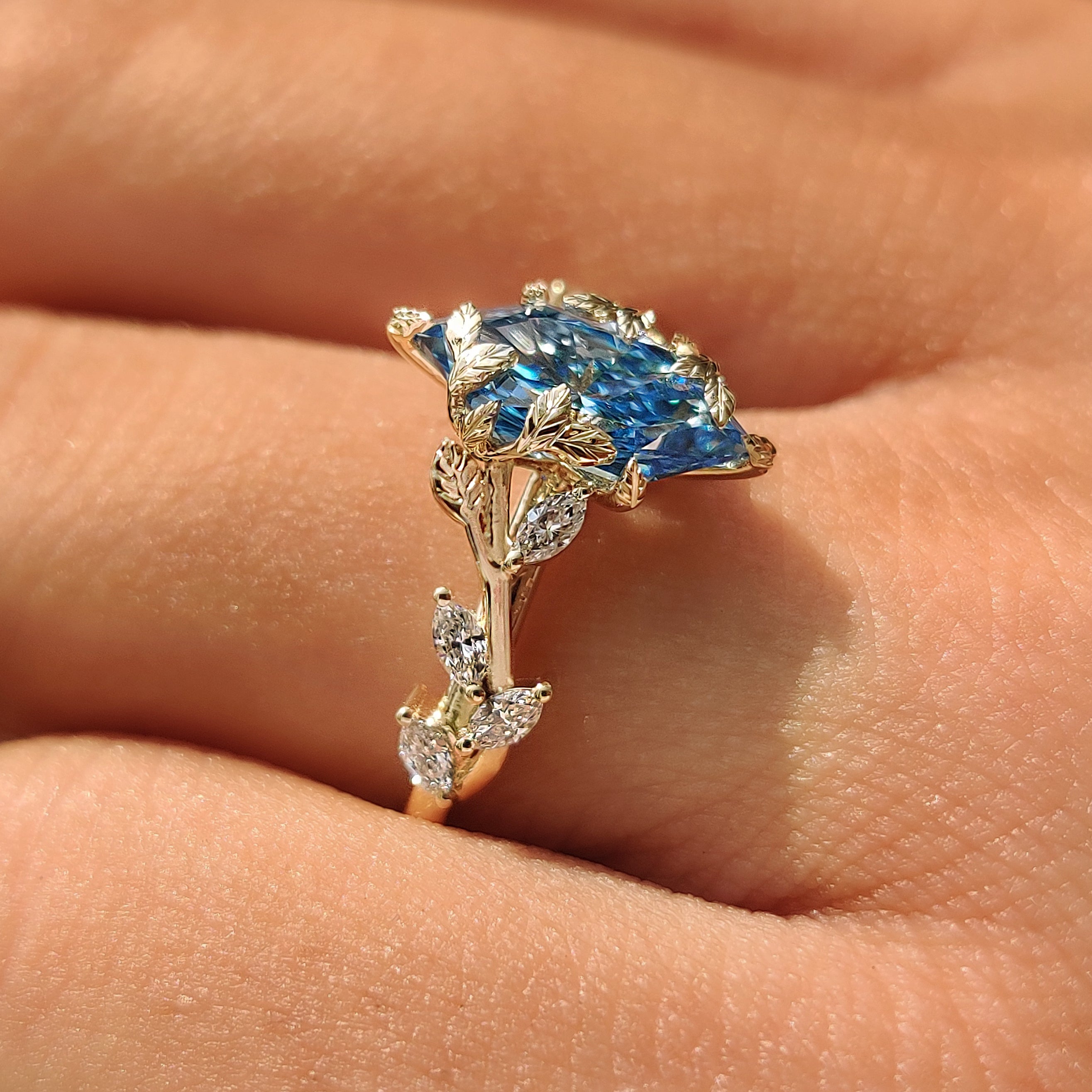 Marquise side stones on a blue Dutch marquise engagement ring.

