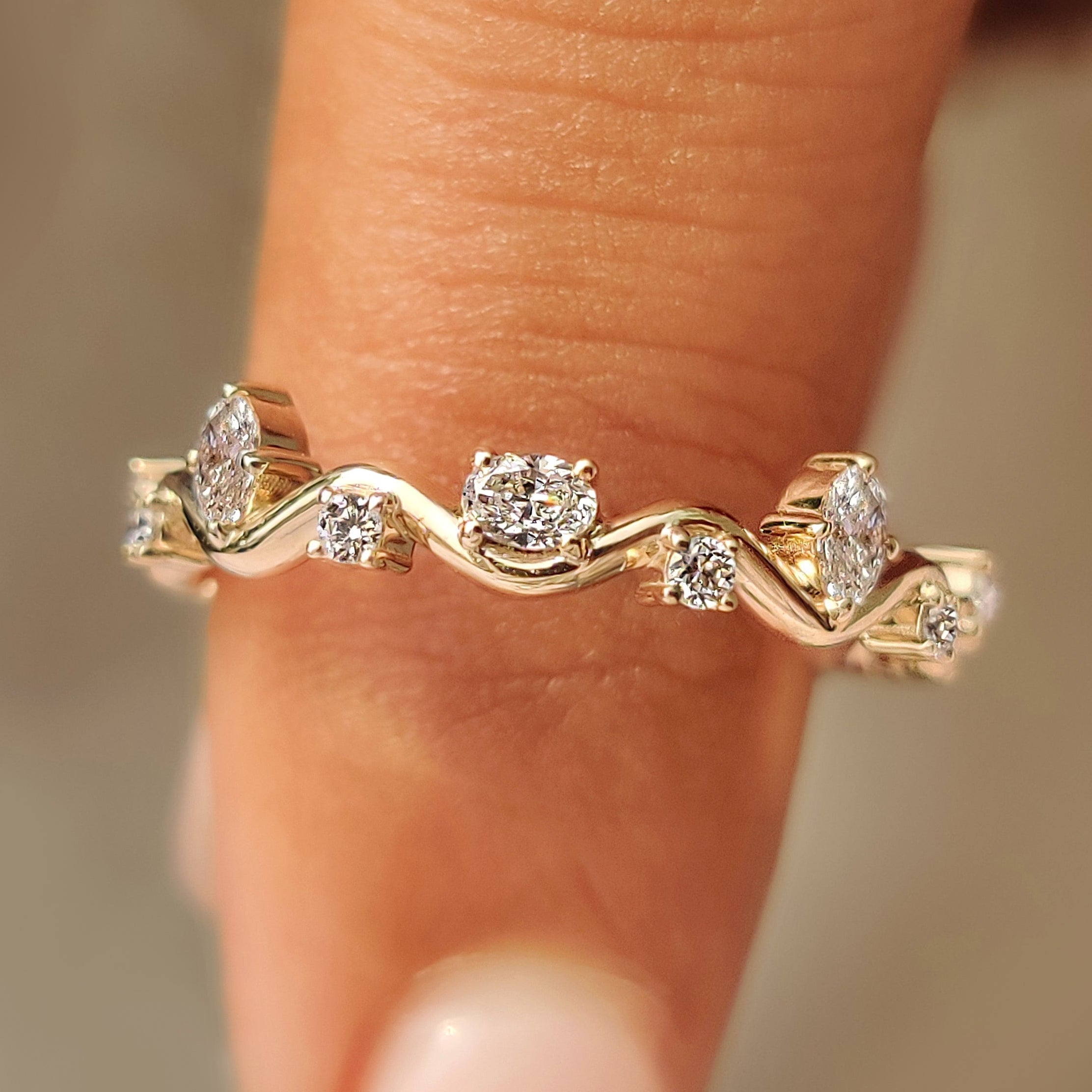 Oval and round diamond fluid wave eternity band.
