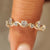 Oval and round diamond fluid wave eternity band.
