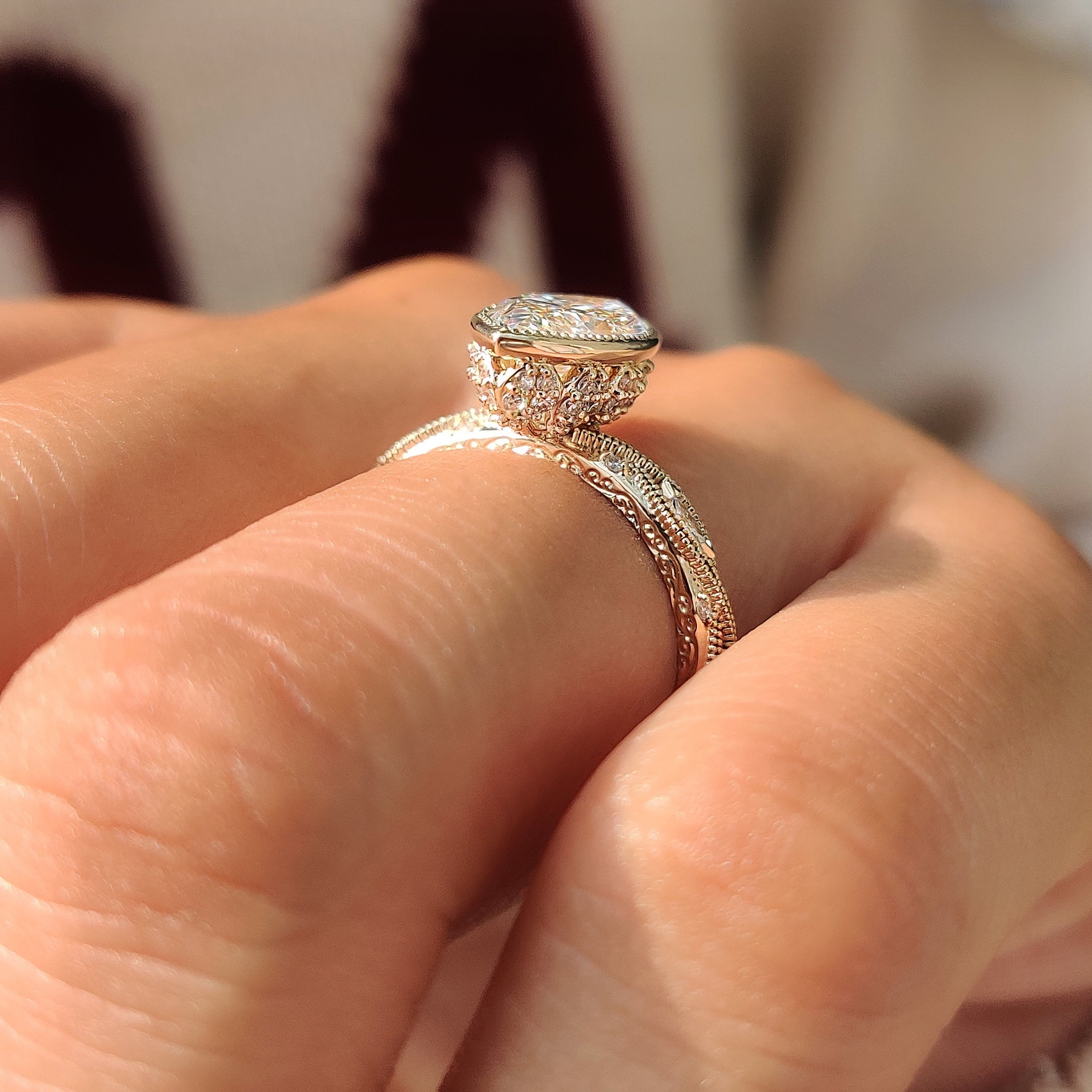 Filigree shank on a yellow gold marquise engagement ring.
