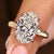 Hidden halo engagement ring with oval cut diamond
