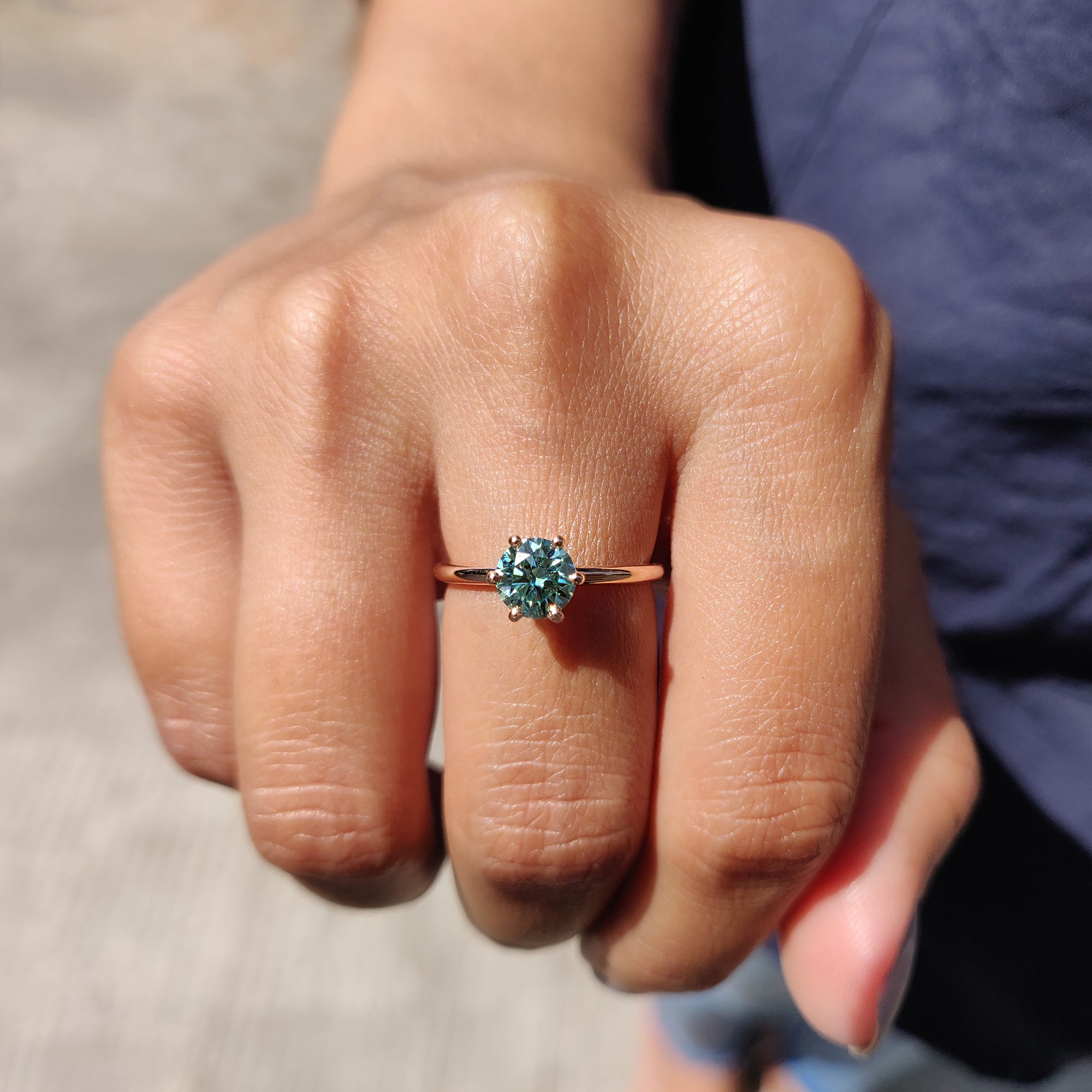 The green solitaire ring adds a unique pop of color to the design.
