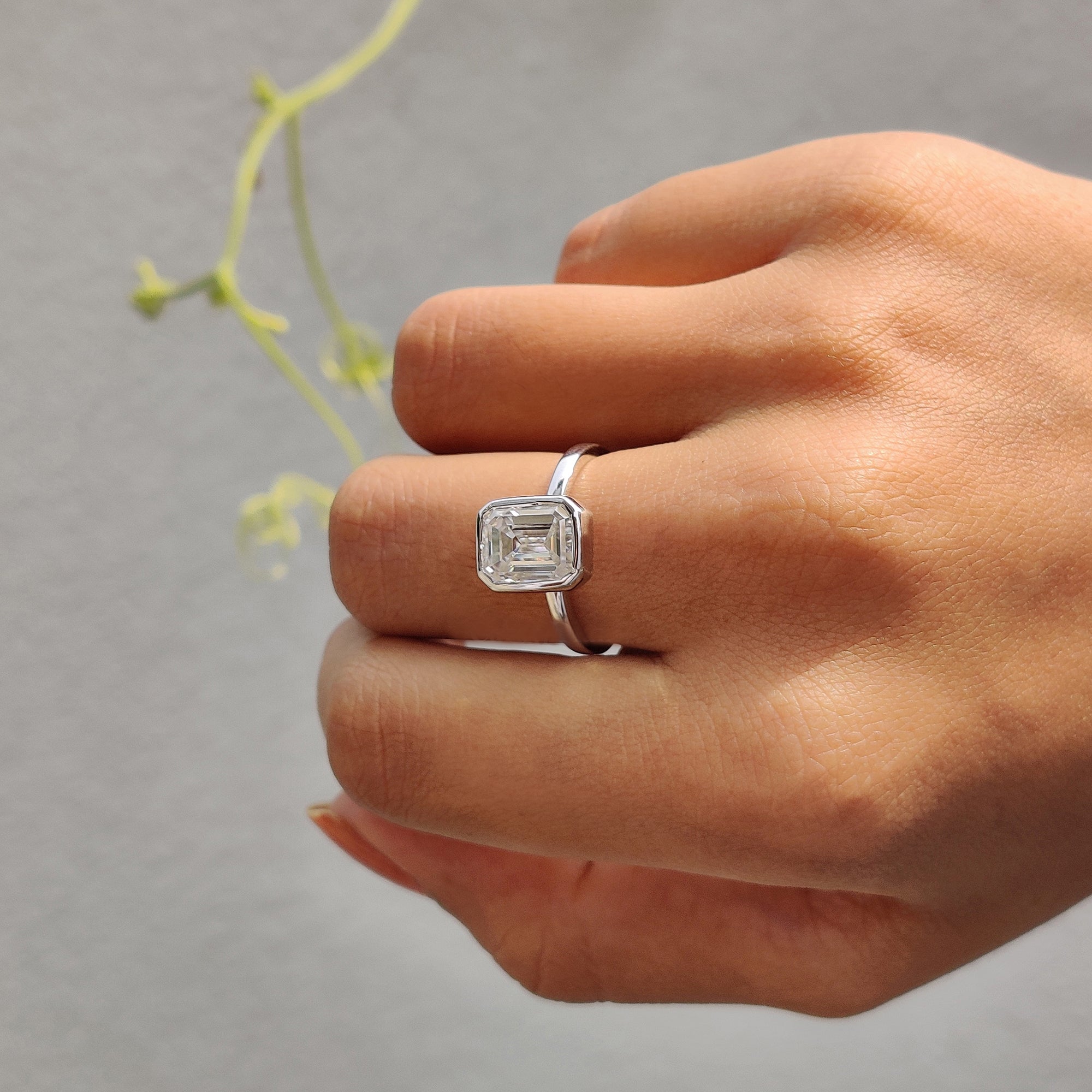 The bezel setting ring features a sleek design.