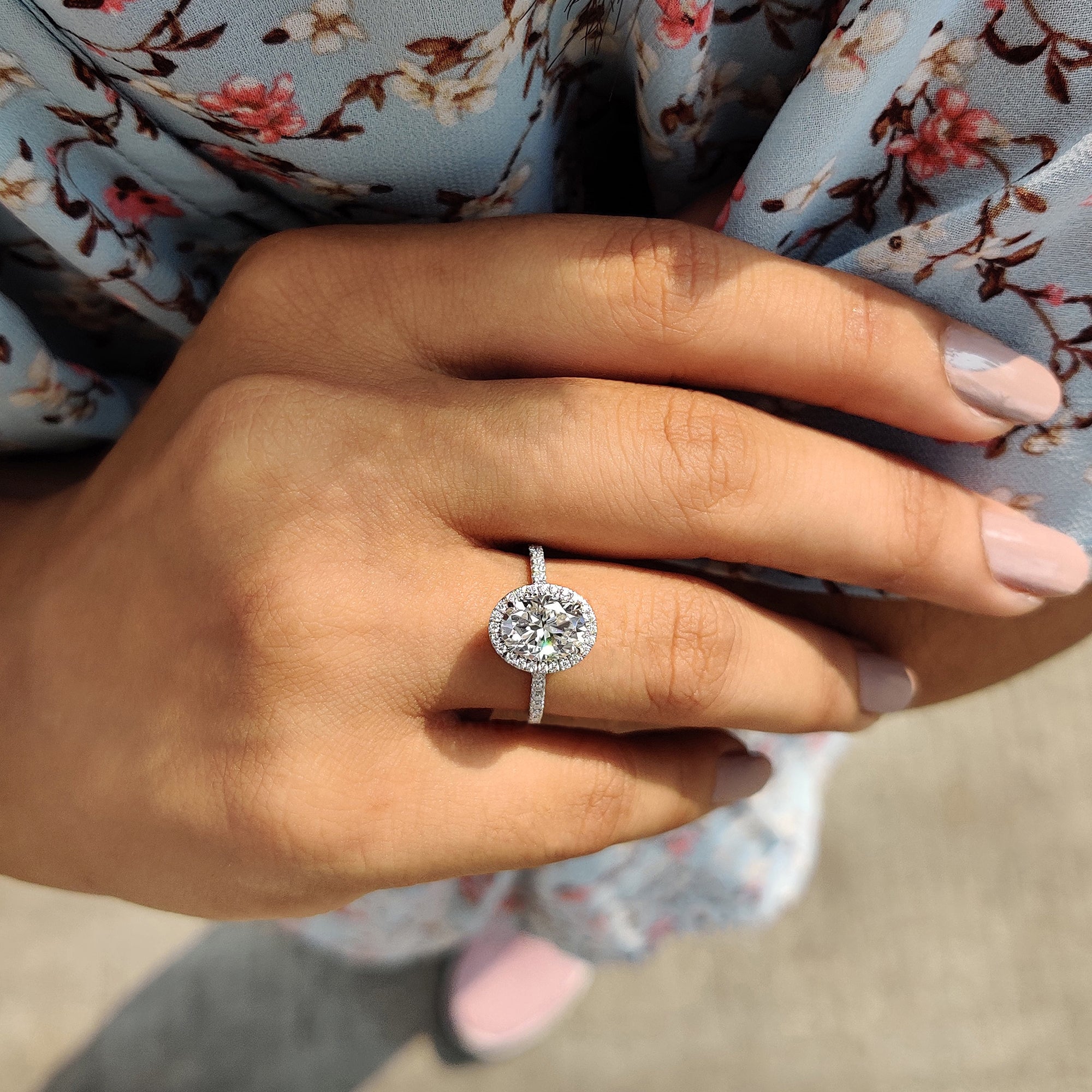 The oval halo ring creates a beautiful, sparkling frame around the gemstone.
