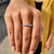 White gold moissanite band alongside east west eternity band.