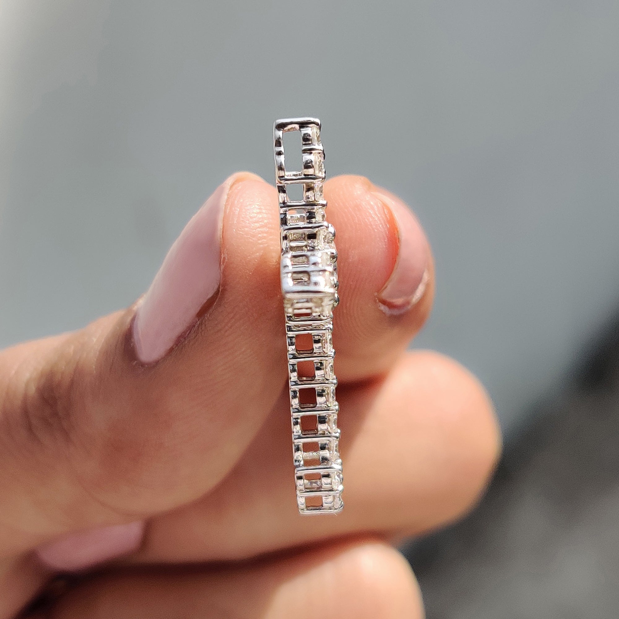 Religion pendant styled as a Criss Cross Pendant with round cut moissanite pendant.
