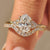 Oval engagement ring set with curved diamond wedding band.
