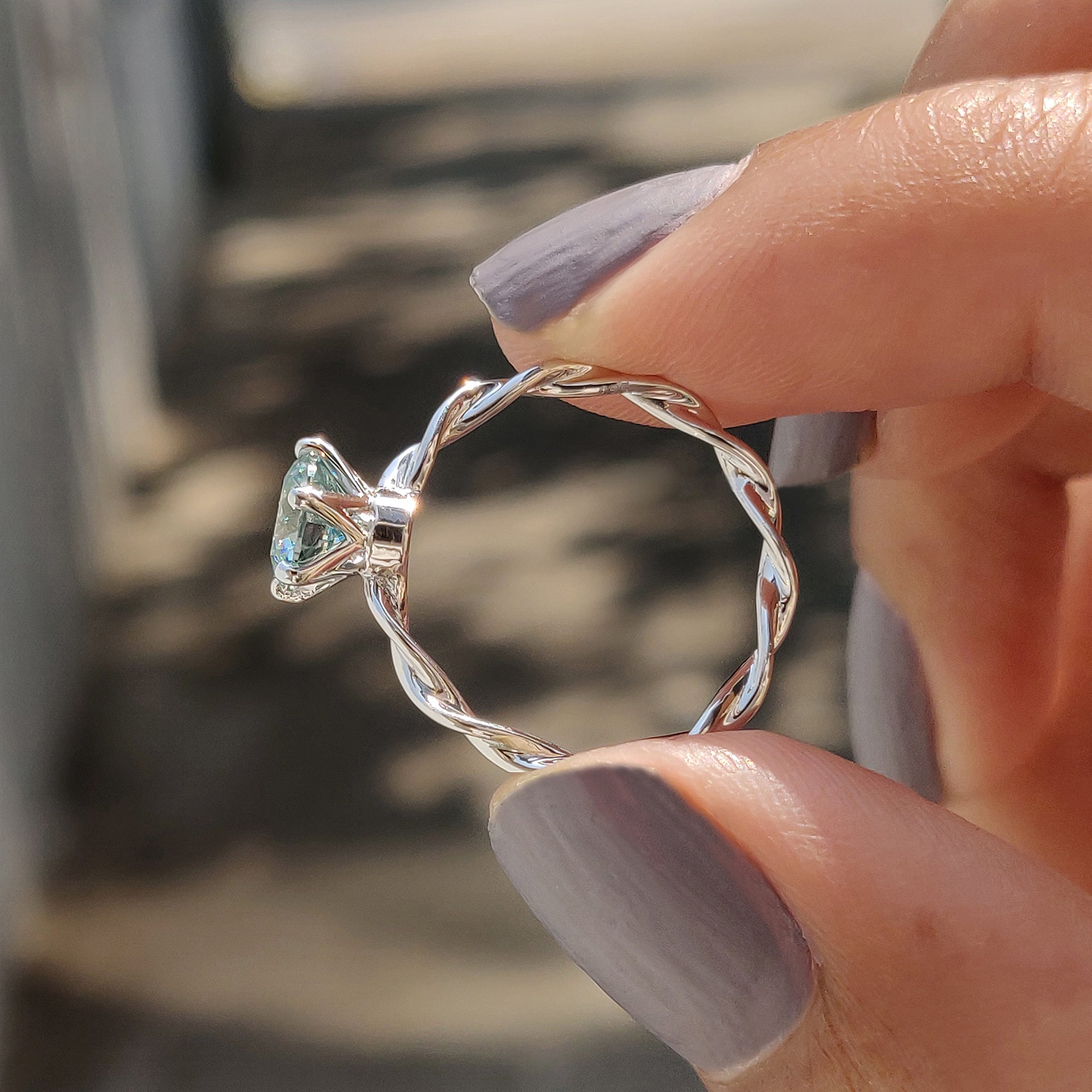 An aqua blue engagement ring adds a vibrant and unique touch to your proposal.
