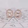Taurus earrings in rose gold with round diamond halo studs.
