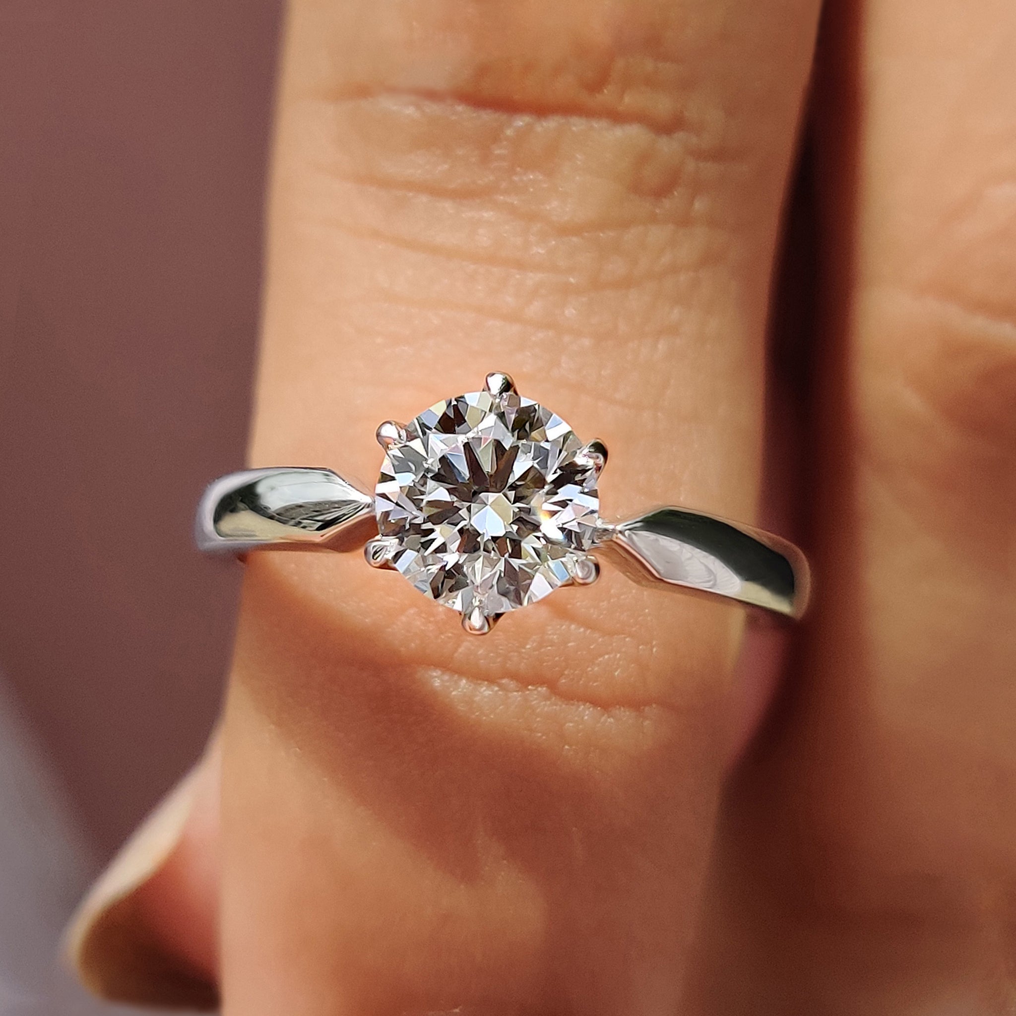 Round solitaire engagement ring with tapered shank ring.
