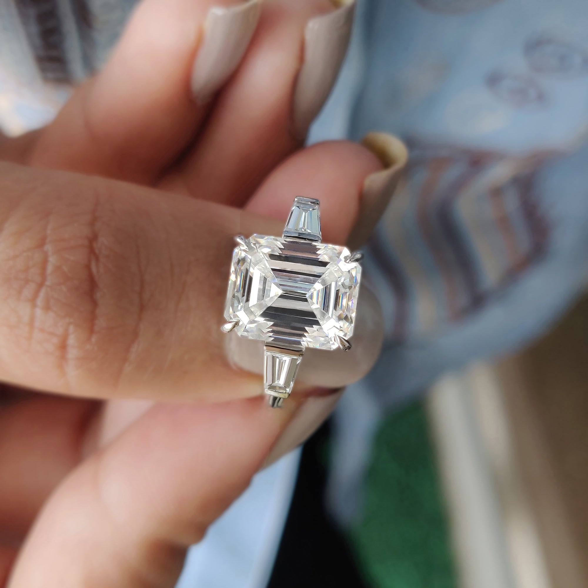 The tapered baguette side stone design adds a touch of elegance and refinement.