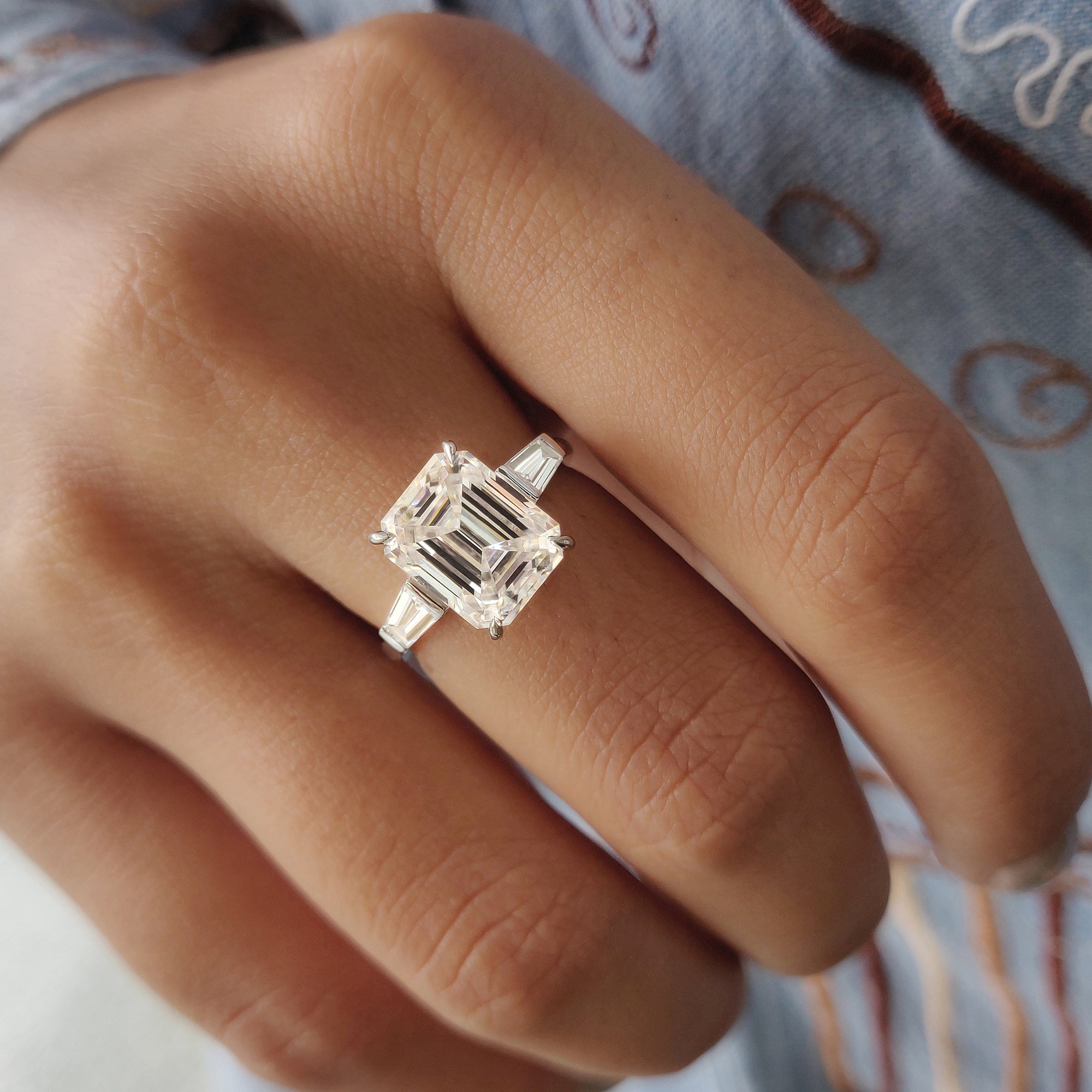 Two side stone tapered baguette accents enhance the center gemstone's brilliance.