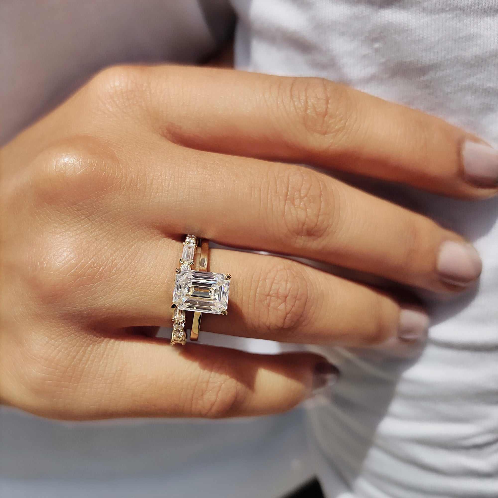 Baguette wedding band paired with an emerald cut ring in a caratdiamond bridal set.
