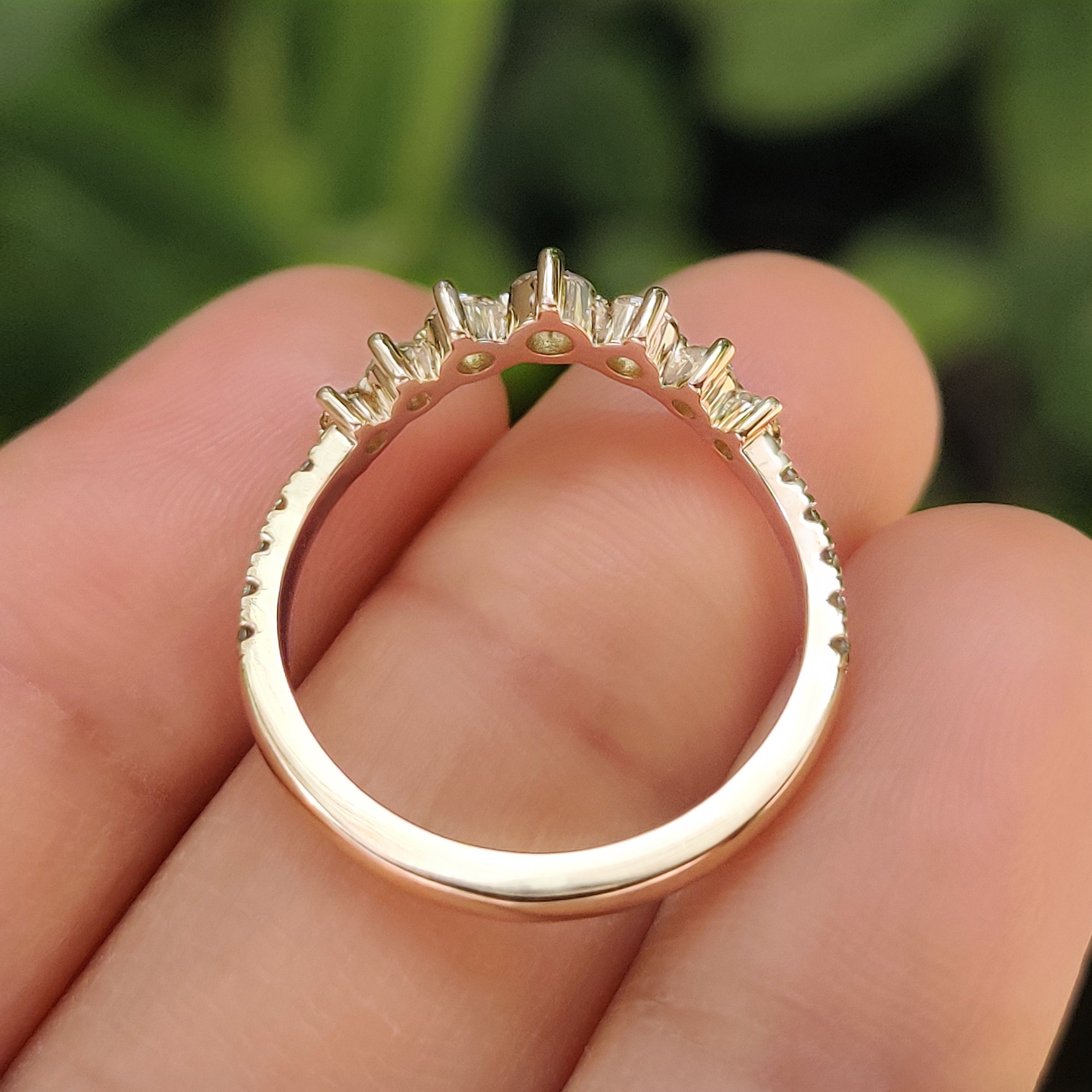 Half eternity band with green diamonds and shared prongs
