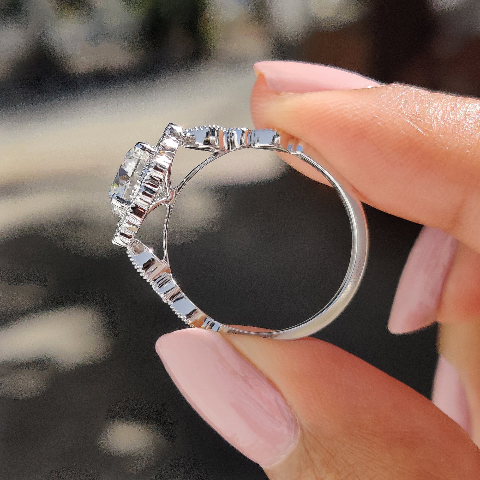 Round moissanite ring sparkling in natural light.
