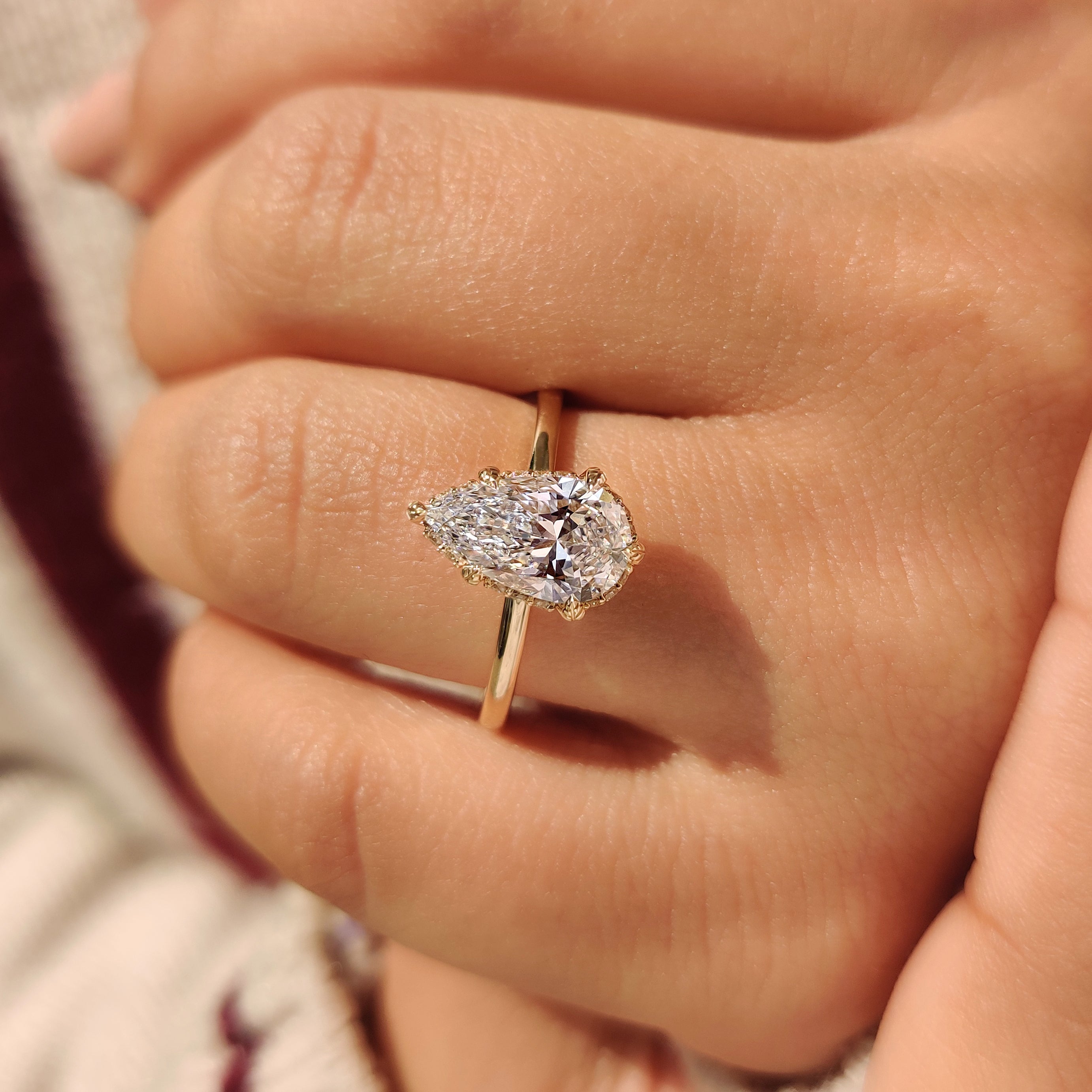 Solitaire pear diamond ring with leaf prong setting.
