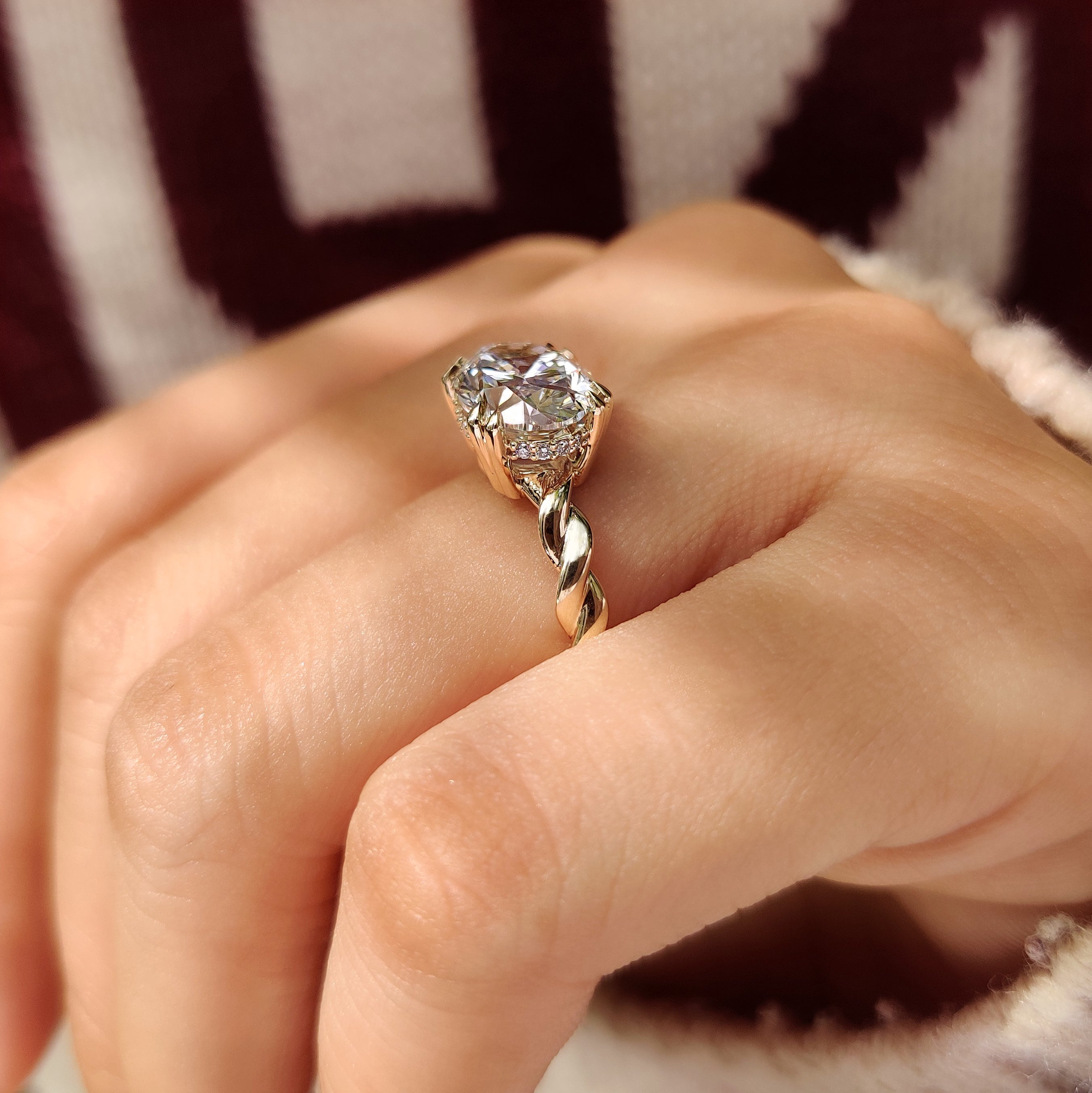Handmade oval diamond ring with twisted shank and halo
