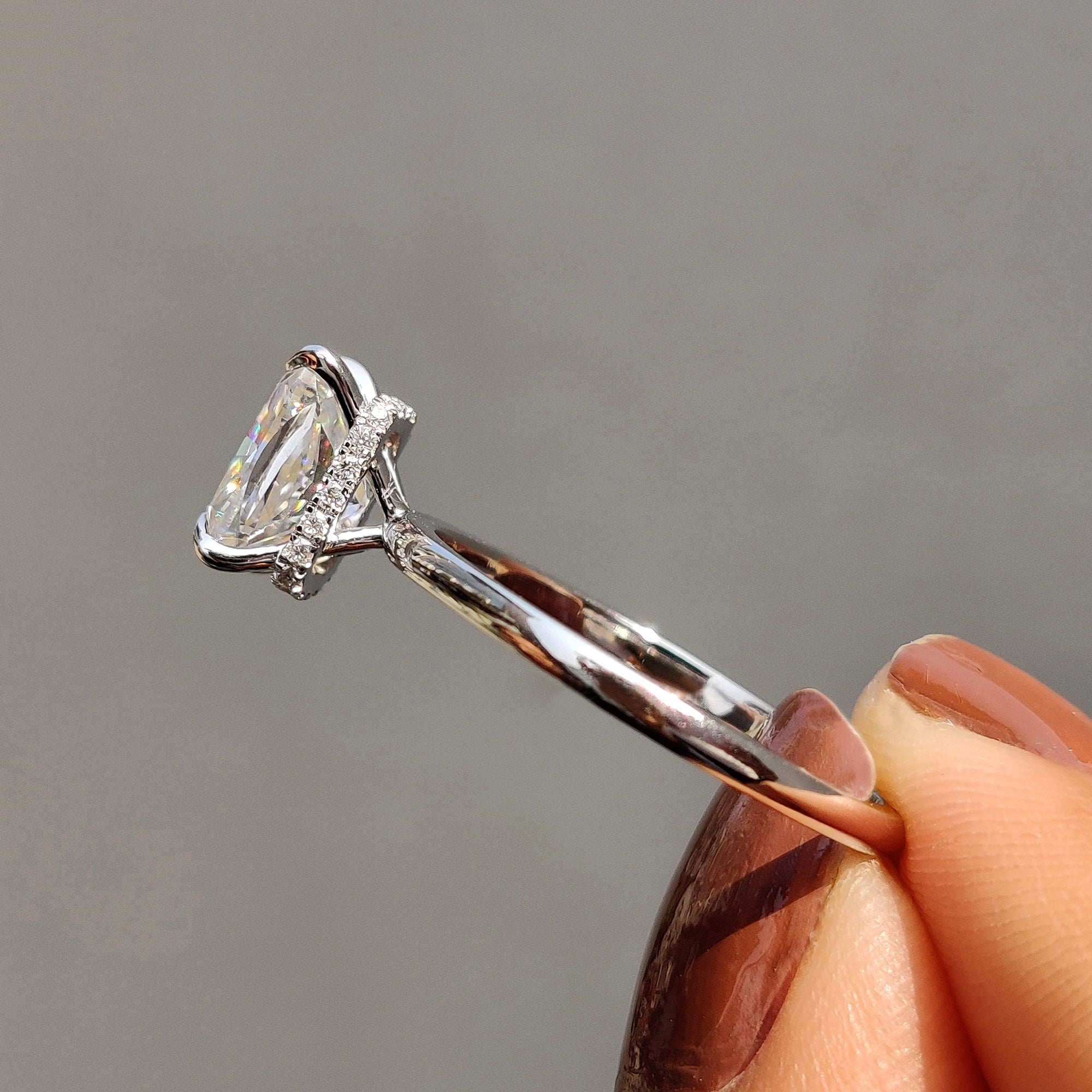 A cushion cut moissanite ring adds vintage-inspired charm.
