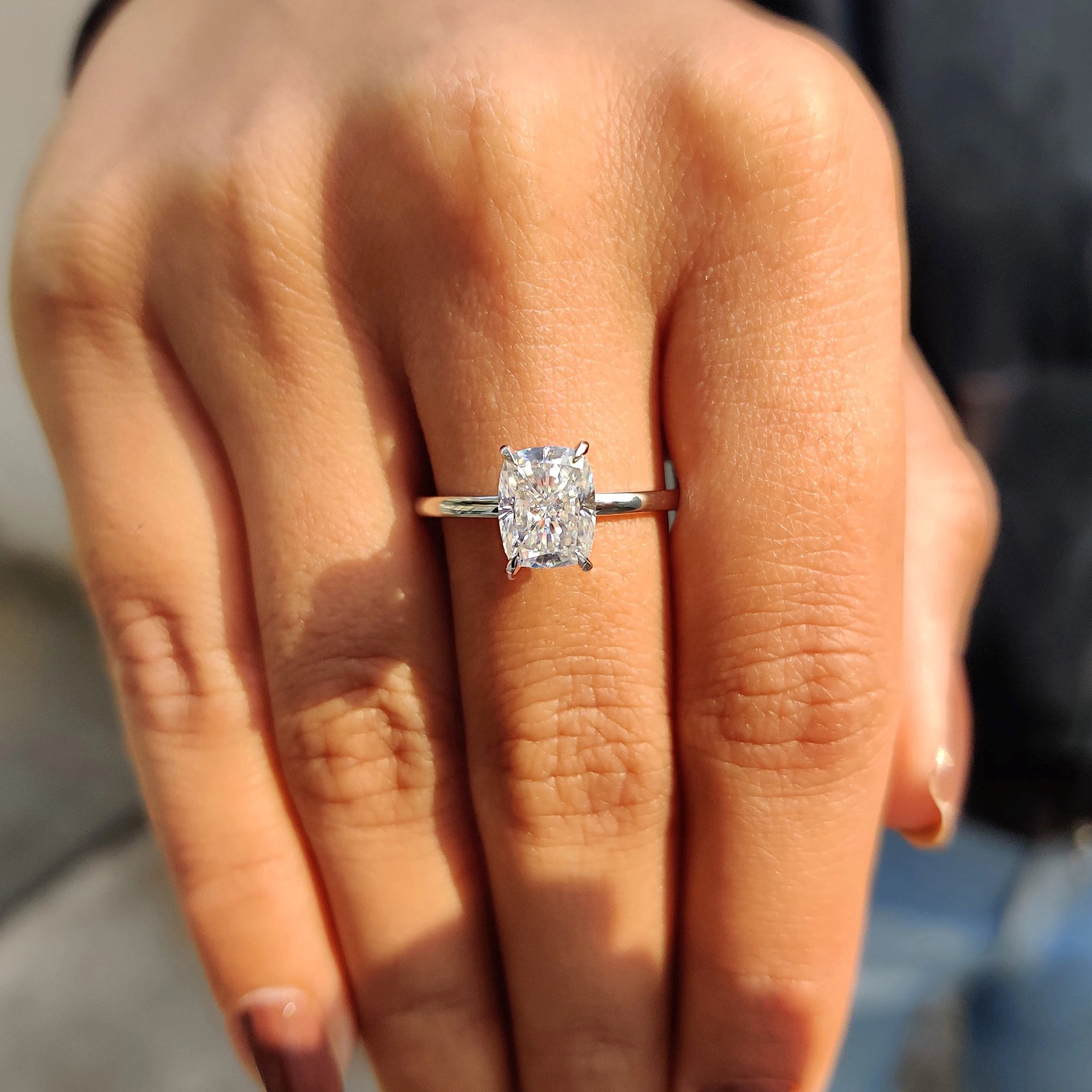 She chose a cushion cut engagement ring for its soft, rounded edges.
