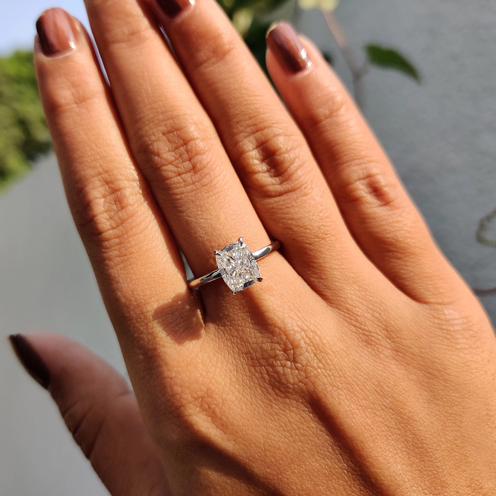 A round cut hidden halo ring brings layered depth to the design.
