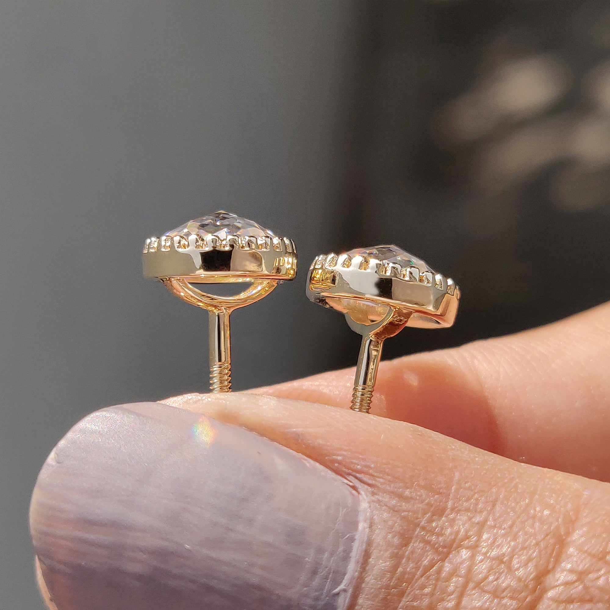 Bezel set Moissanite Earrings featuring round rose cut stones and screw back earrings.
