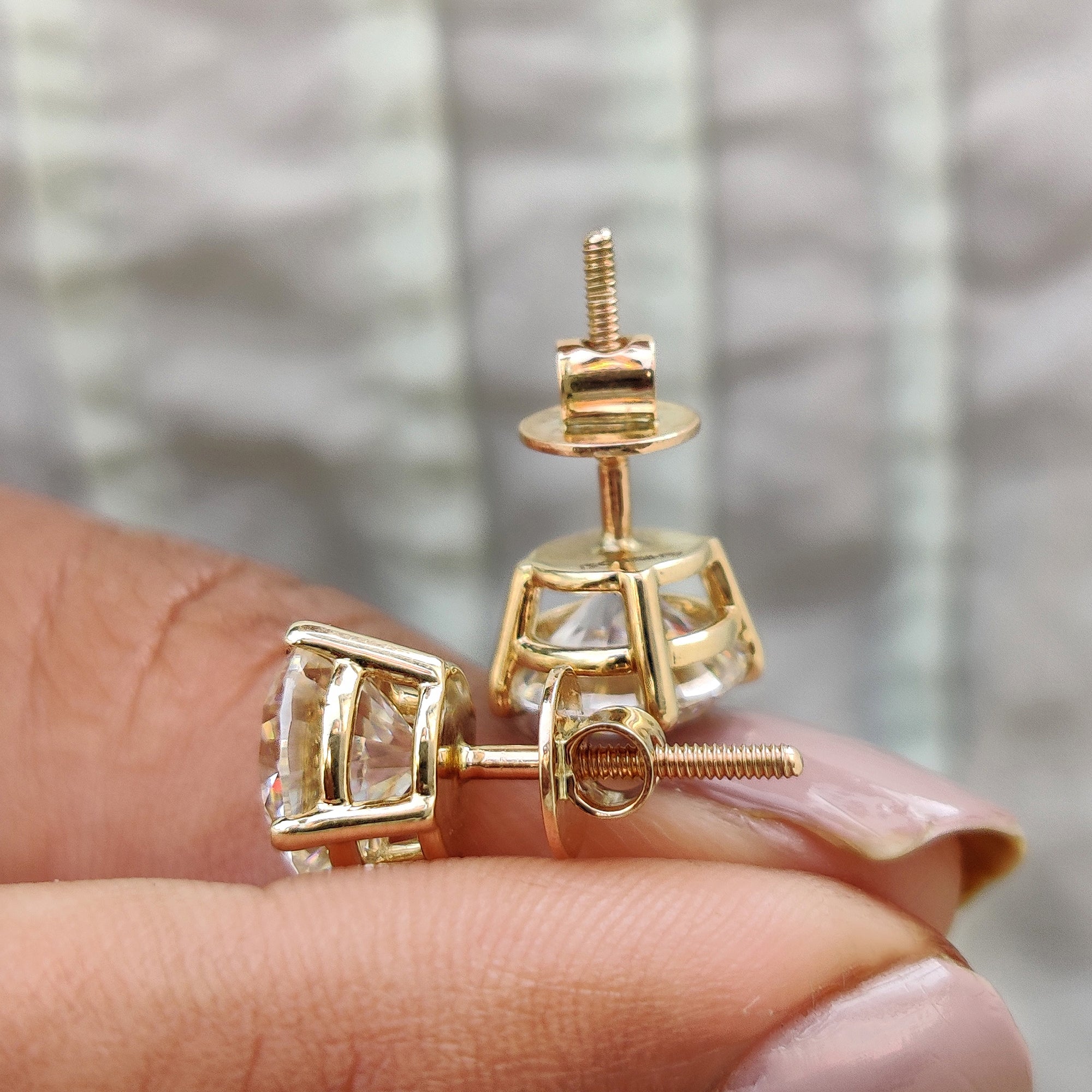 4 claw prong setting holding round cut earrings made with Lab Grown Moissanite.
