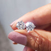Round cut Moissanite Earrings designed with 3 prong setting and white gold earrings for handmade jewelry.
