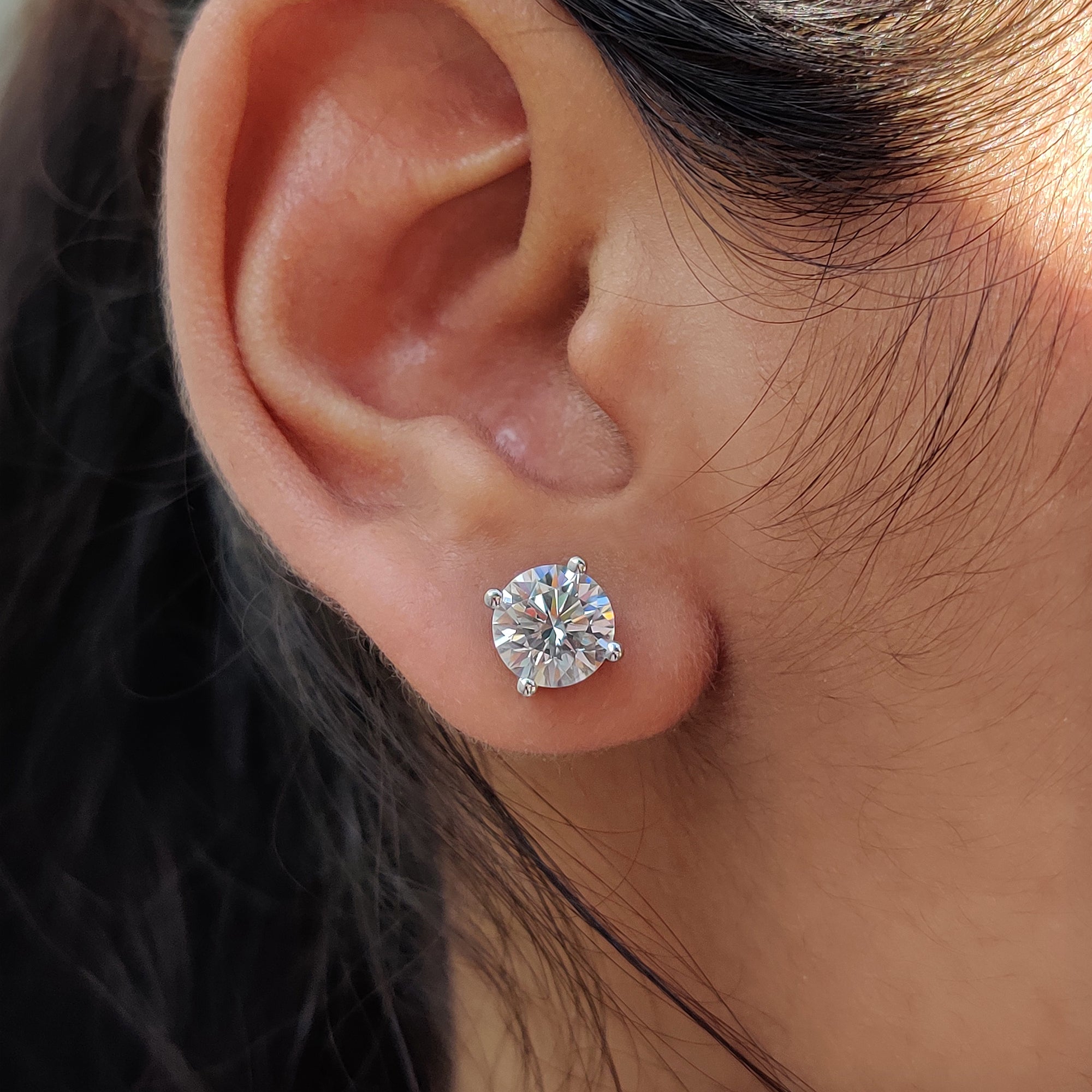 White gold earrings matched with round cut earrings and secure screw back earrings.
