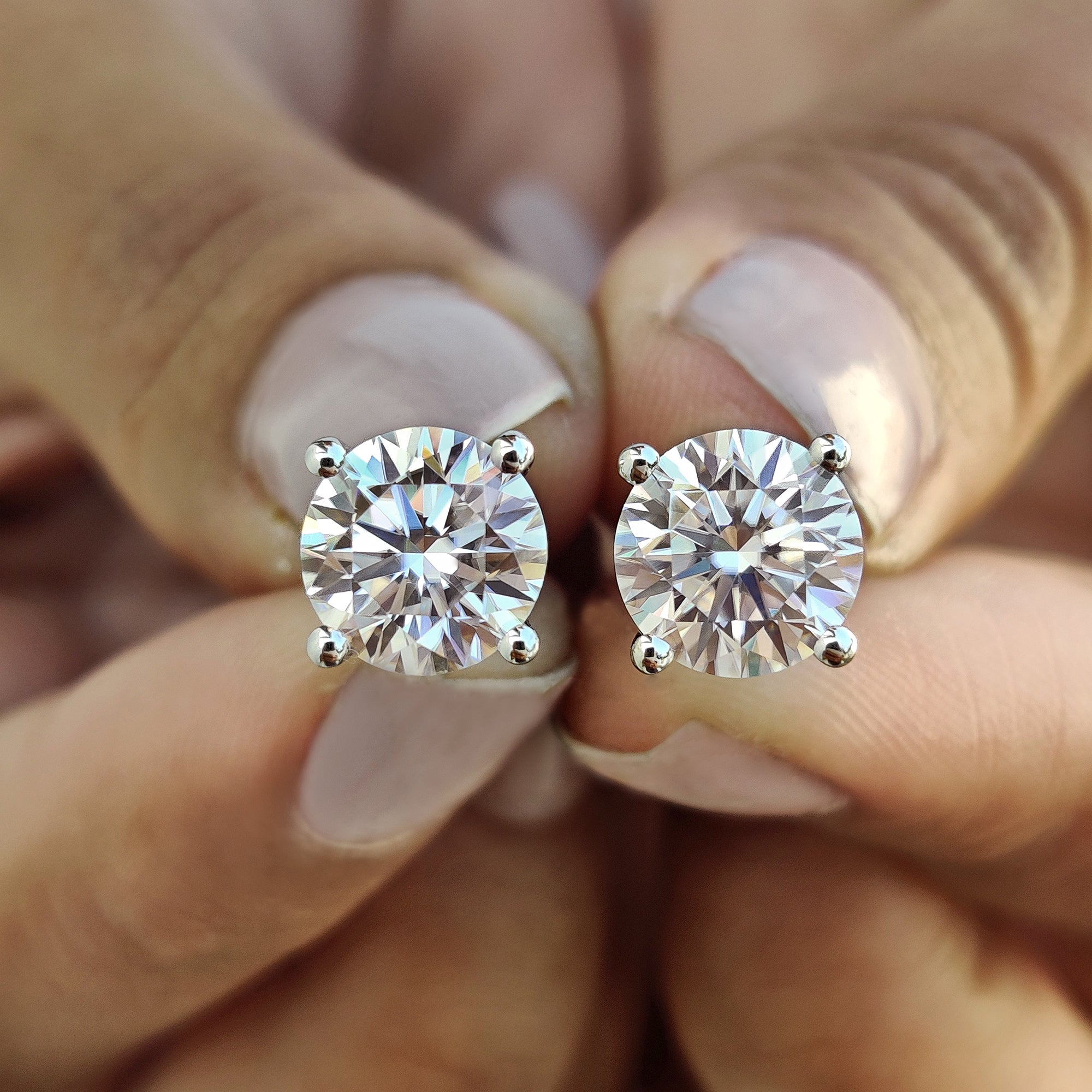 Stud earrings made using round cut Moissanite Earrings and white gold earrings.
