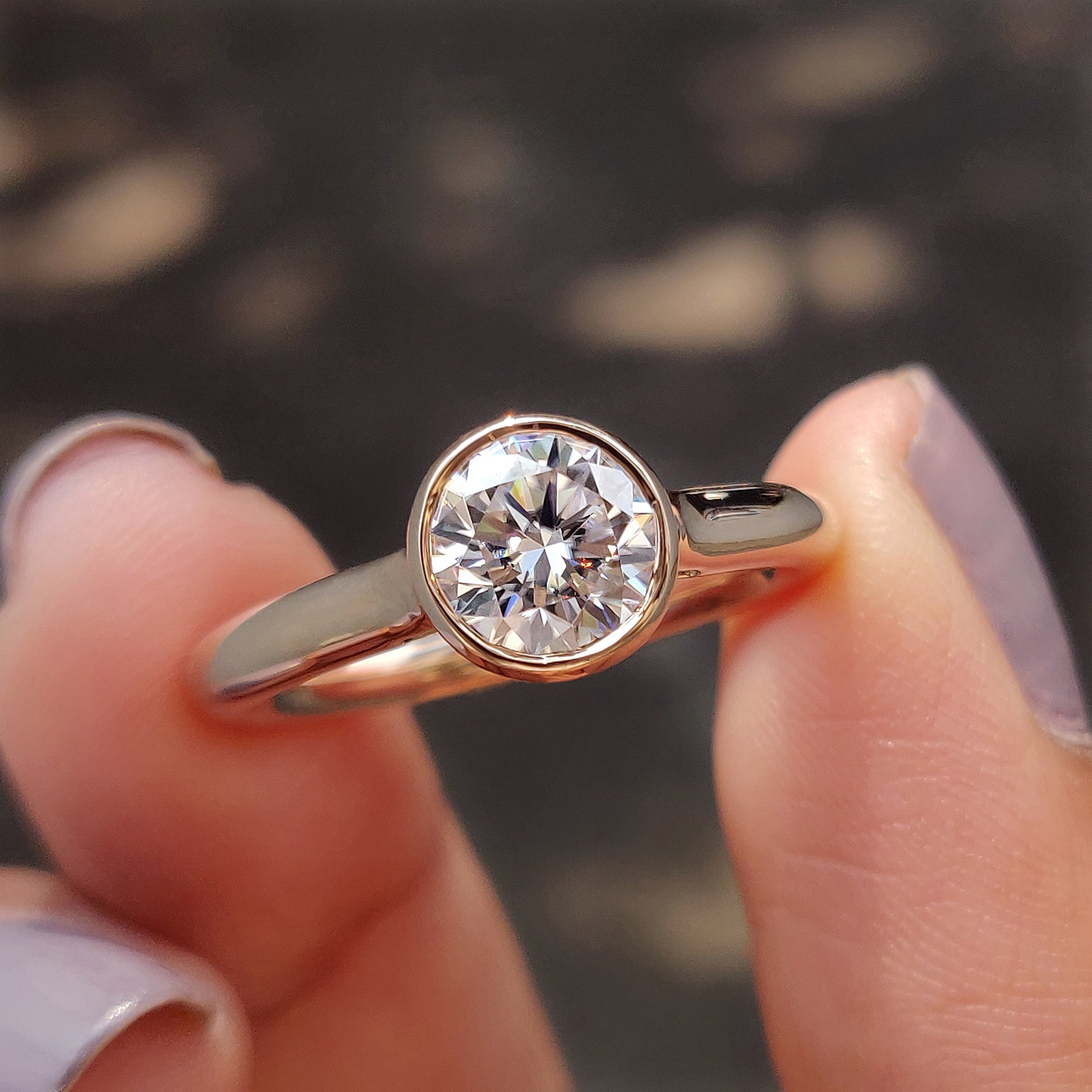 Round bezel engagement ring with moissanite center.