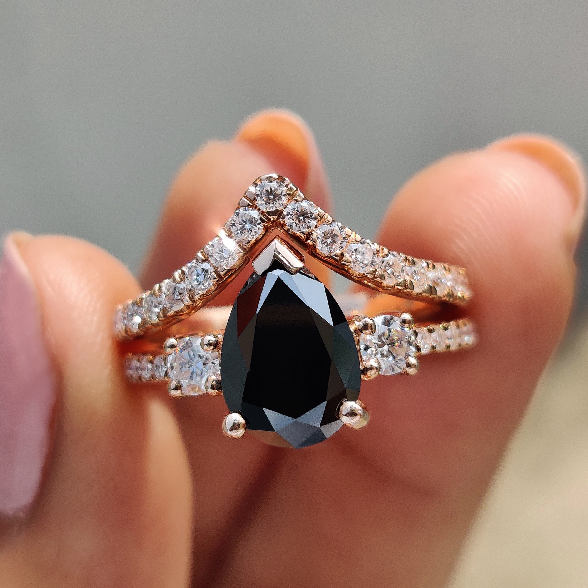 Pear engagement ring with curved wedding band in a rose gold bridal set.
