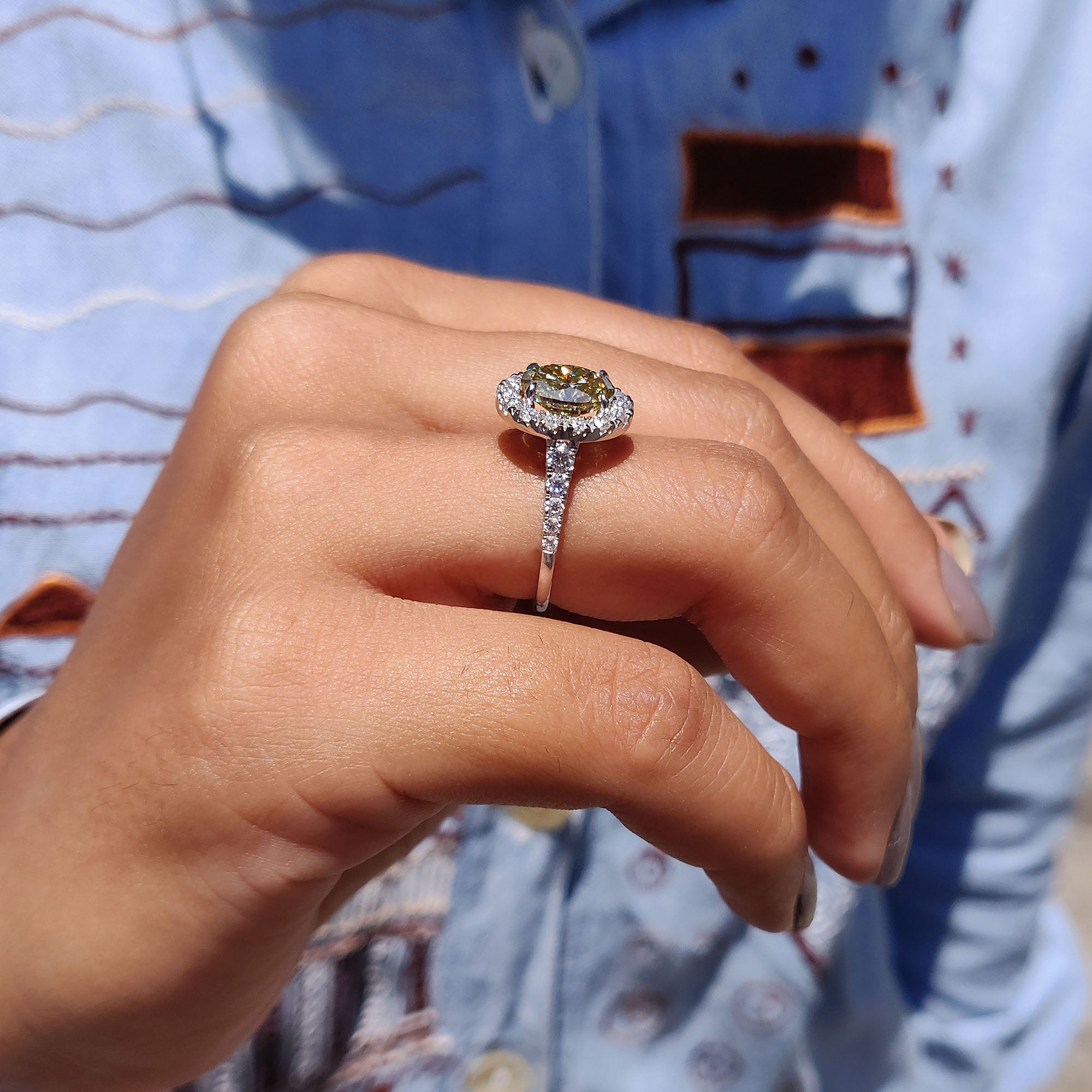 Moissanite ring with a custom micro pave setting and oval cut stone.