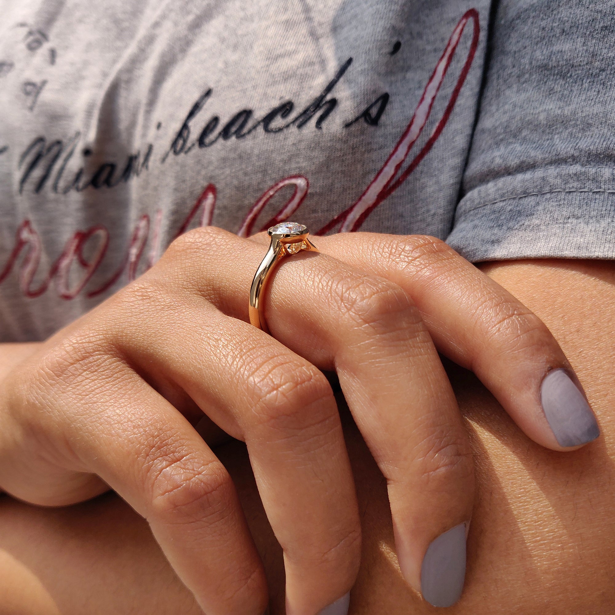 Engagement ring in round cut bezel from Carat Diamonds.