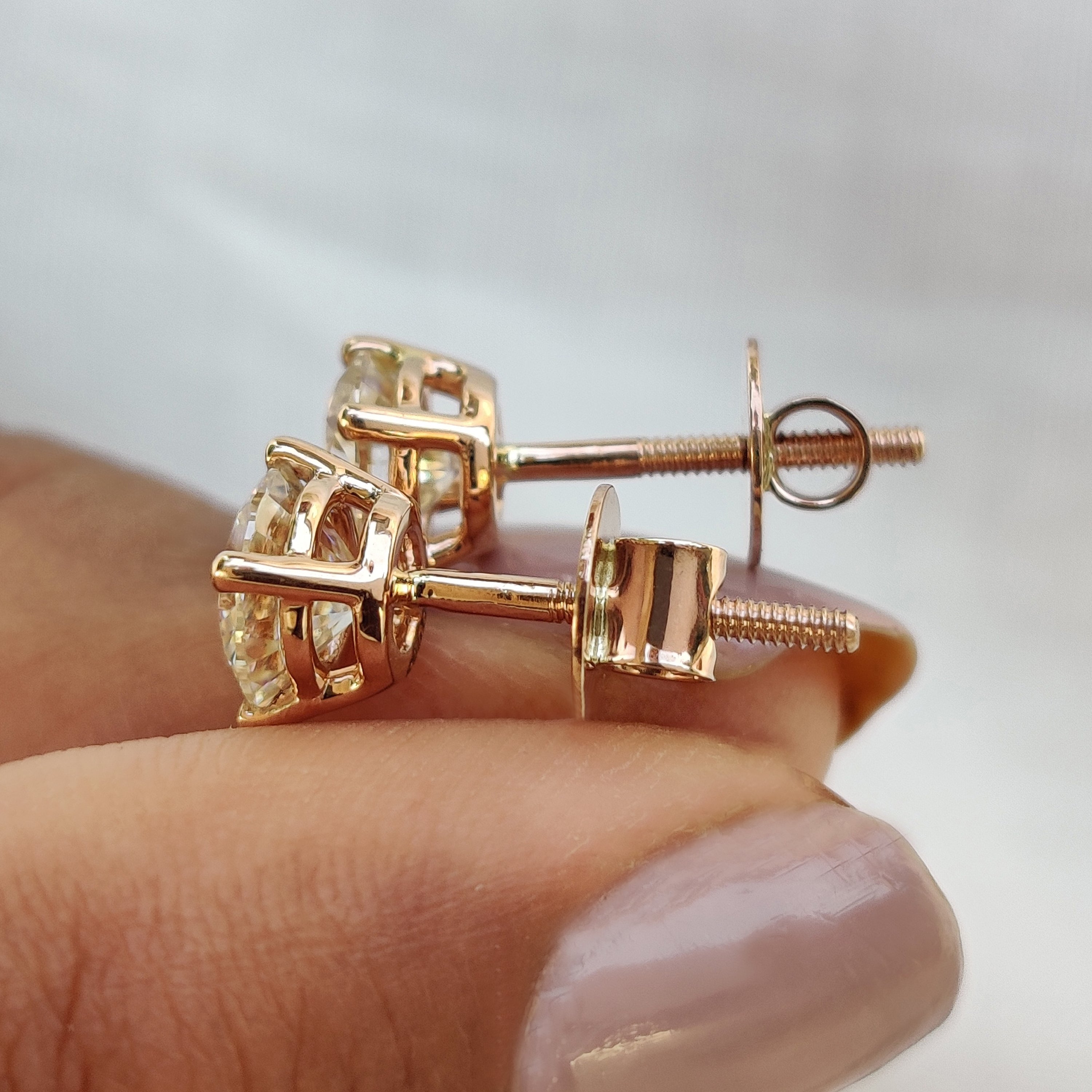 Round cut earrings designed for Wedding Gifts for Women in gold Moissanite Earrings setting.
