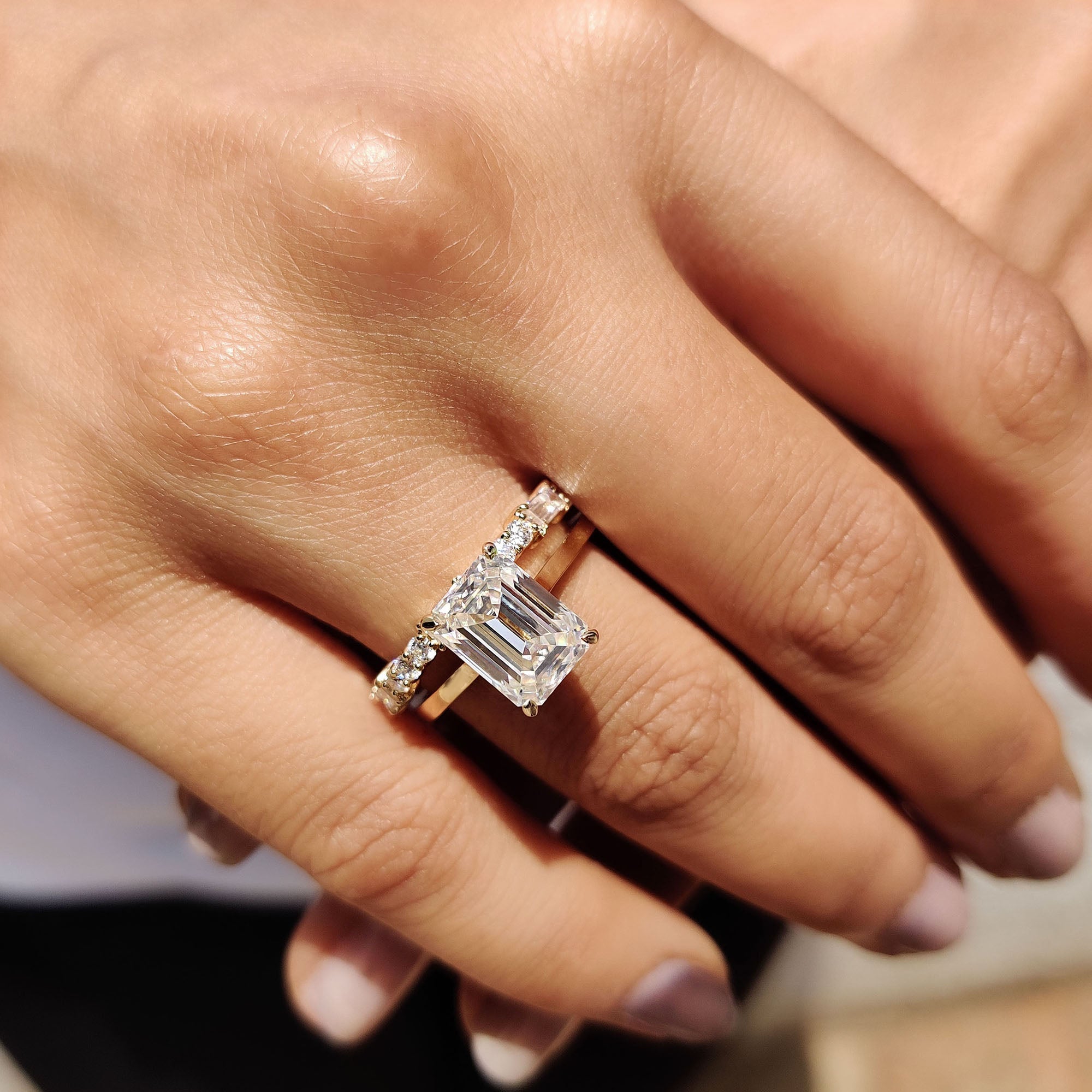Yellow gold bridal set with an emerald cut engagement ring and baguette band.
