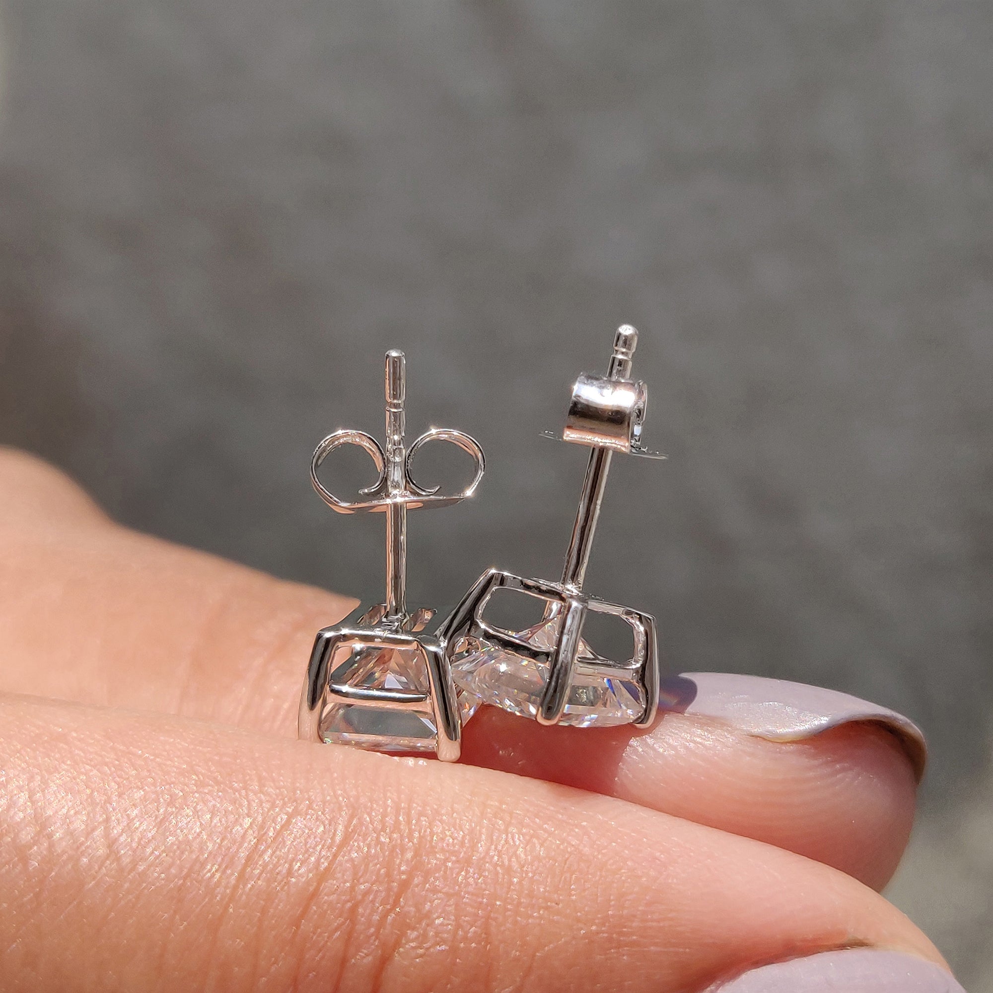 White gold earrings designed with Princess Cut earrings and secure push back earrings.

