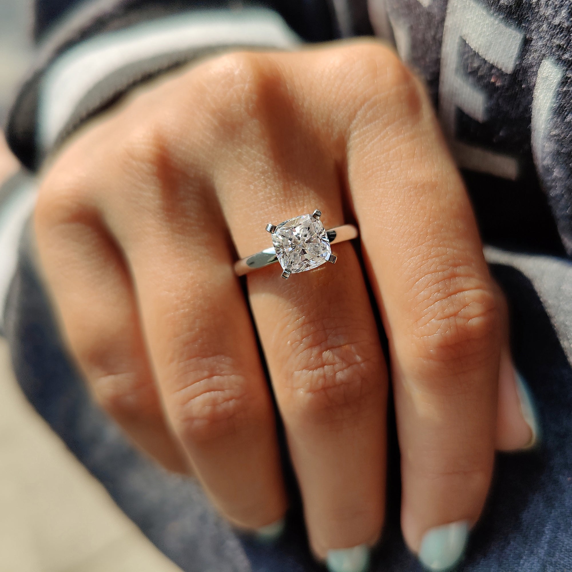 White gold ring with carat diamonds center.
