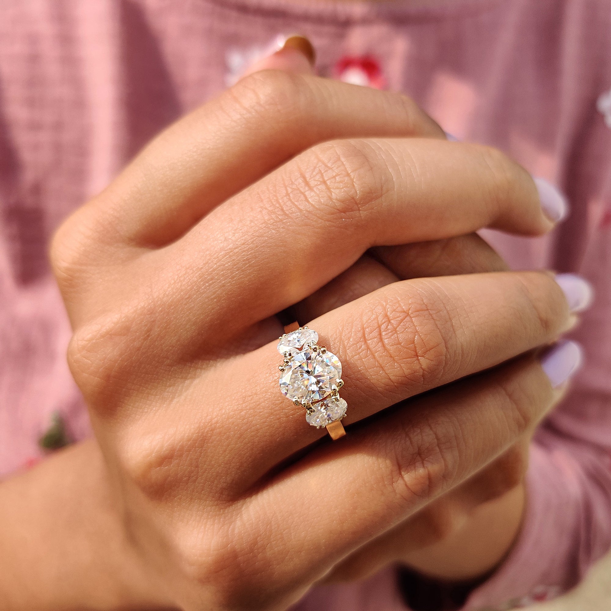 Buy engagement ring featuring an elegant three-stone design.
