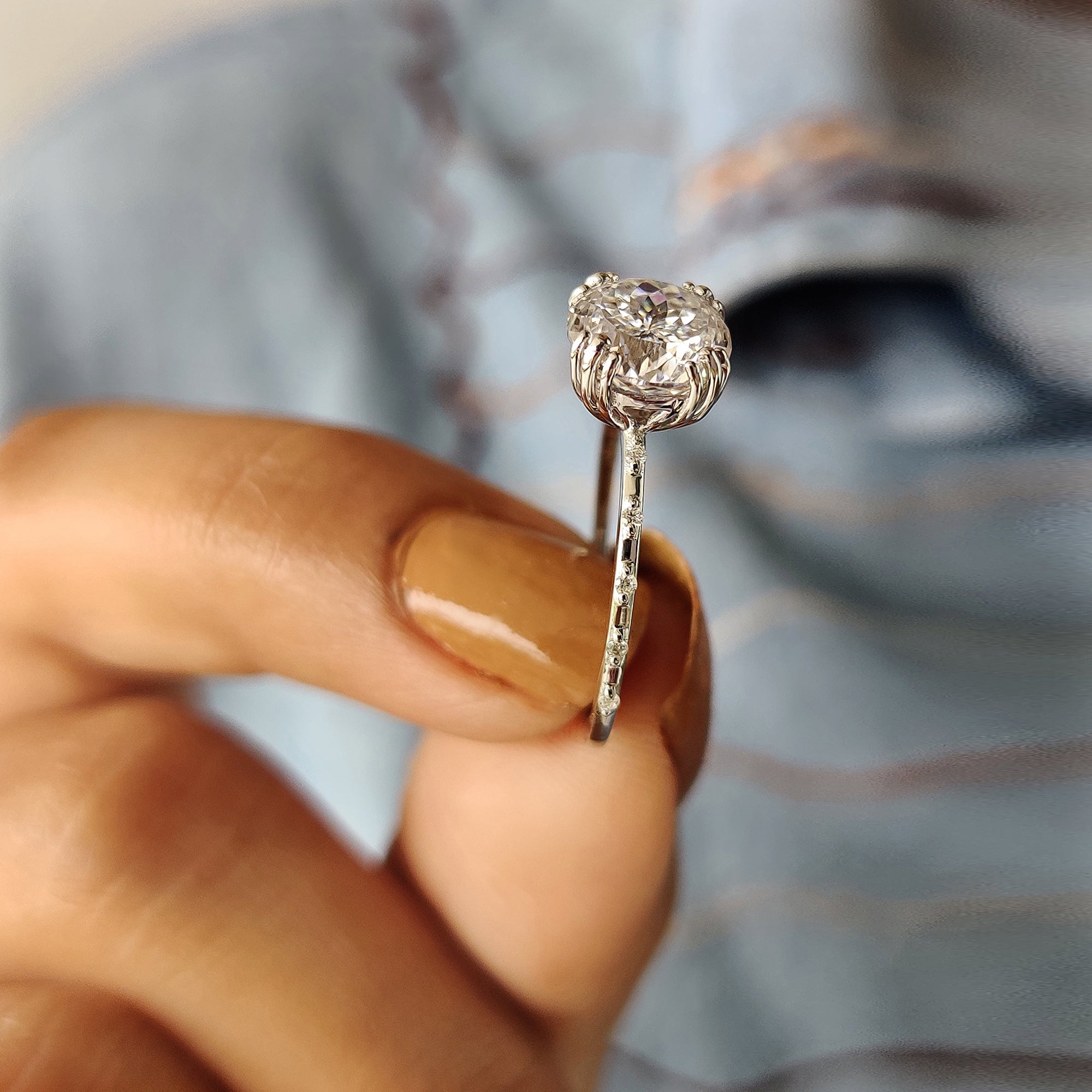 A Portuguese round moissanite ring sparkles with refined beauty.
