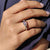 A tapered baguette side stone ring adds sleek elegance to the design.
