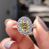 Micro pave ring with a light yellow moissanite stone.