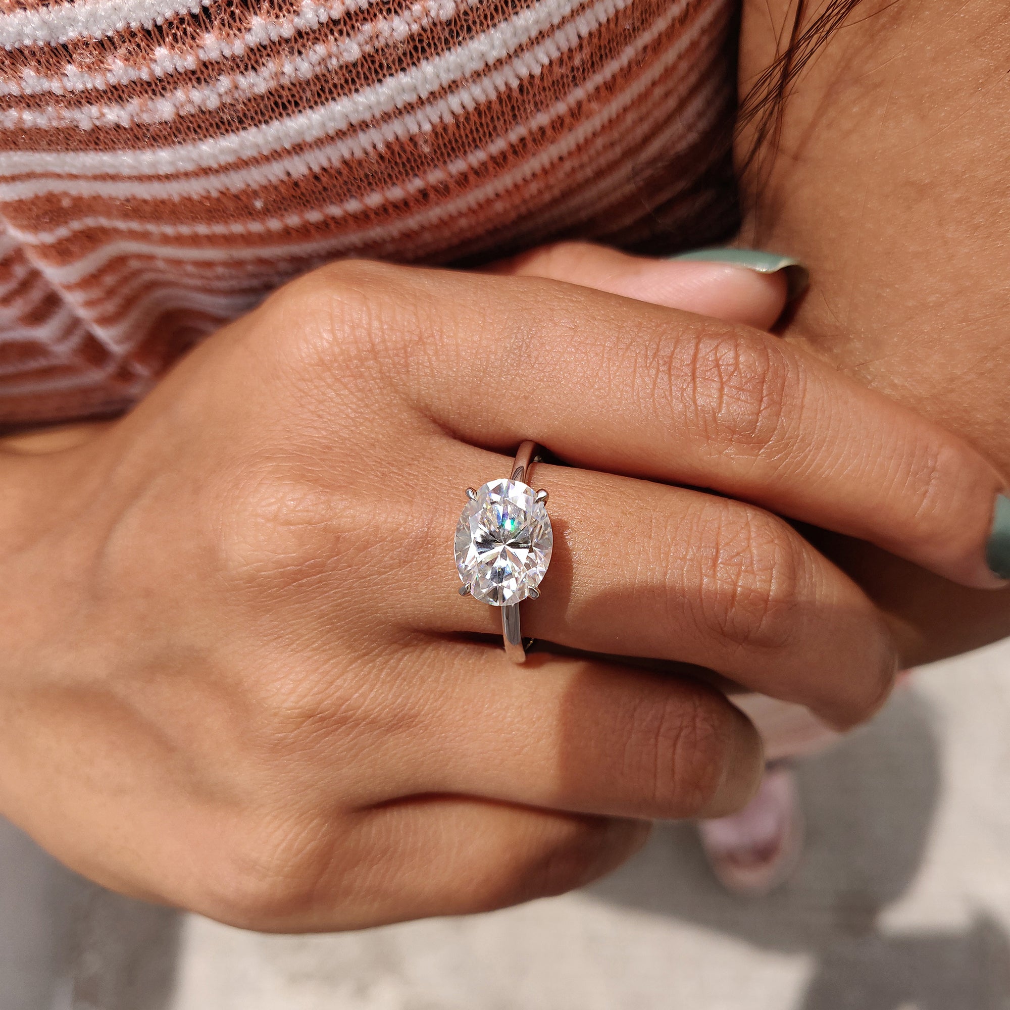 East west engagement ring featuring an oval cut stone.