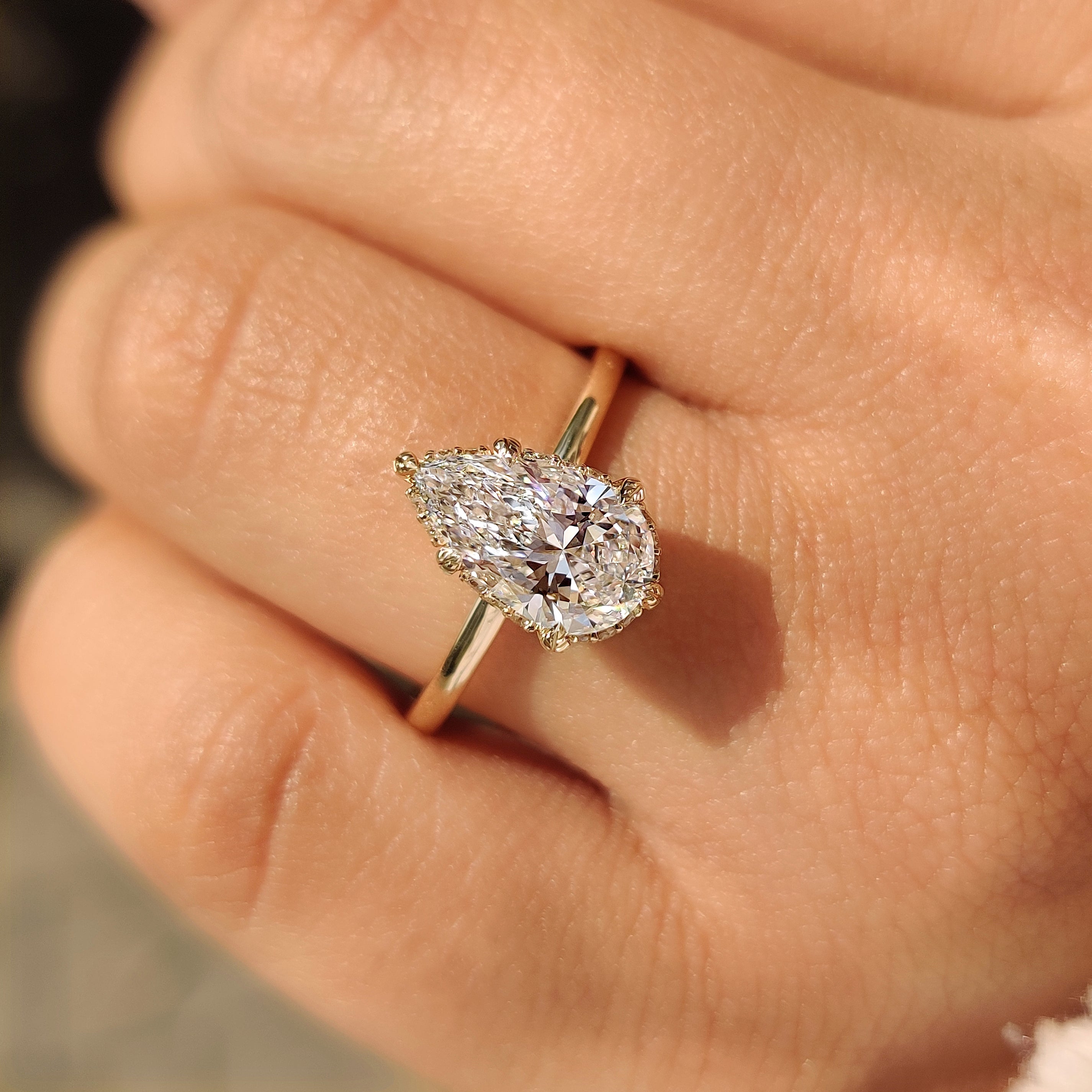 Lab grown pear diamond ring with six prongs.
