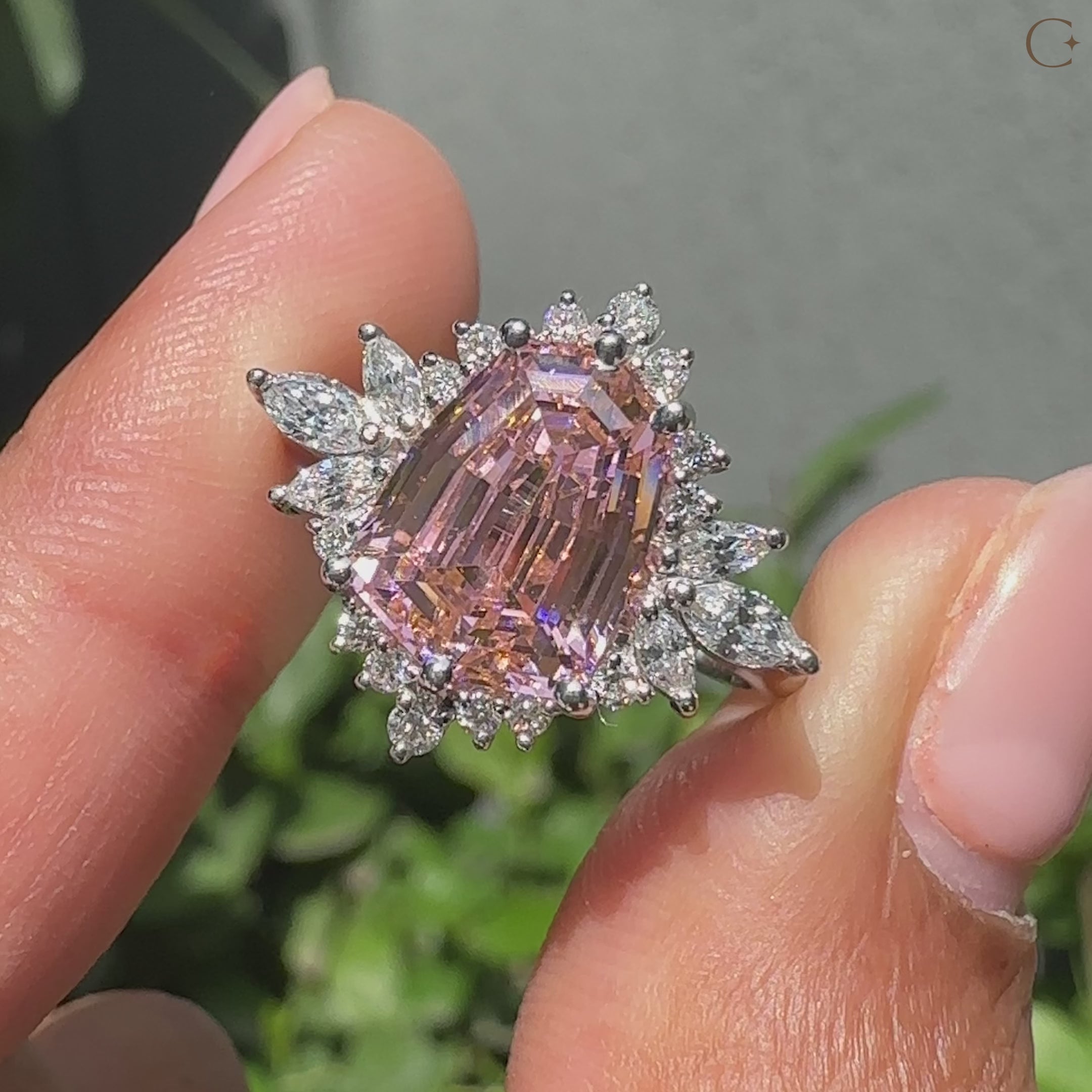 Shield cut engagement ring in vintage cluster ring style.